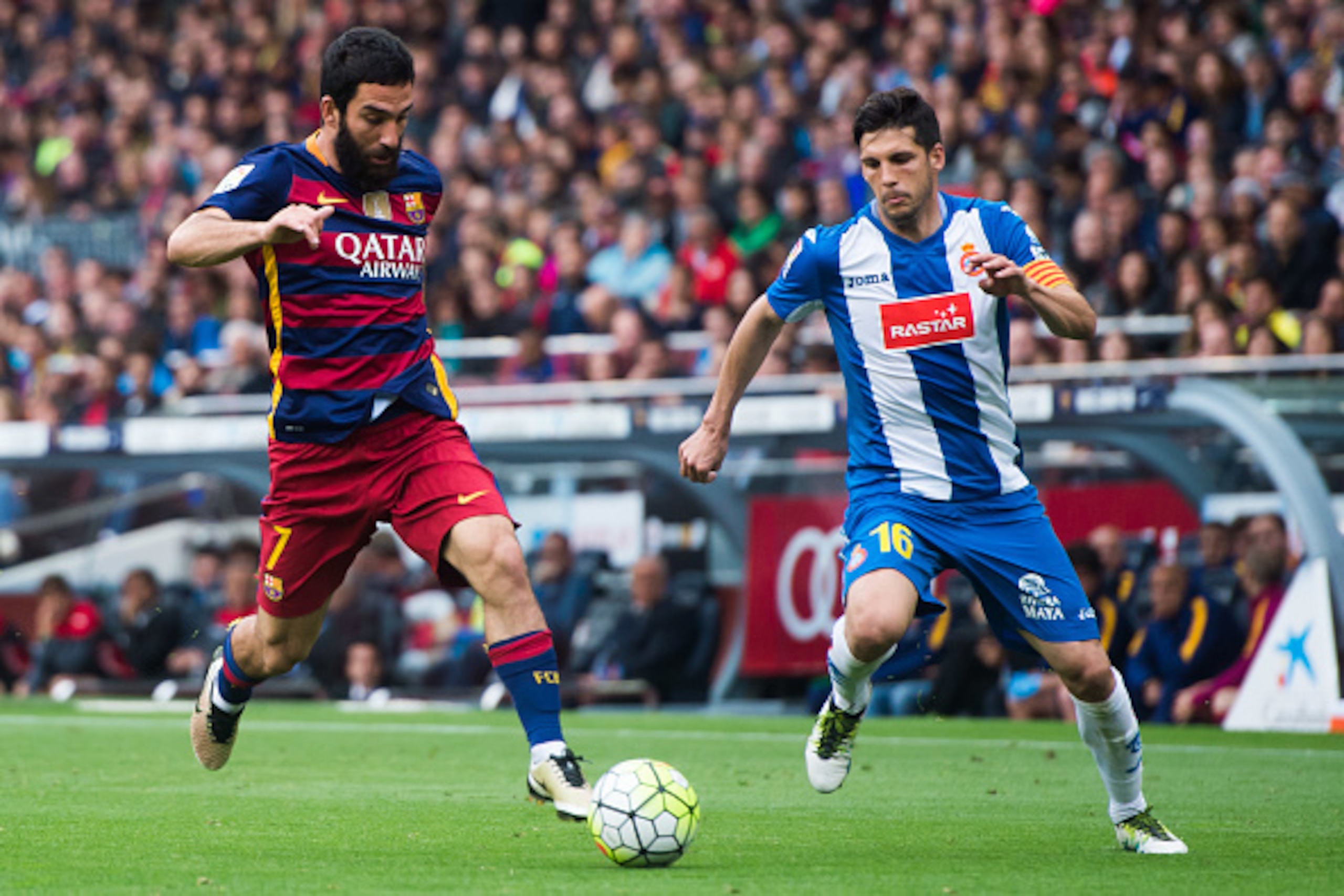 BARCELONA, SPAIN - MAY 08: Arda Turan (L) of FC Barcelona controls the ball next to Javi Lopez of RCD Espanyol during the La Liga match between FC Barcelona and RCD Espanyol at Camp Nou on May 8, 2016 in Barcelona, Spain. (Photo by Alex Caparros/Getty Ima