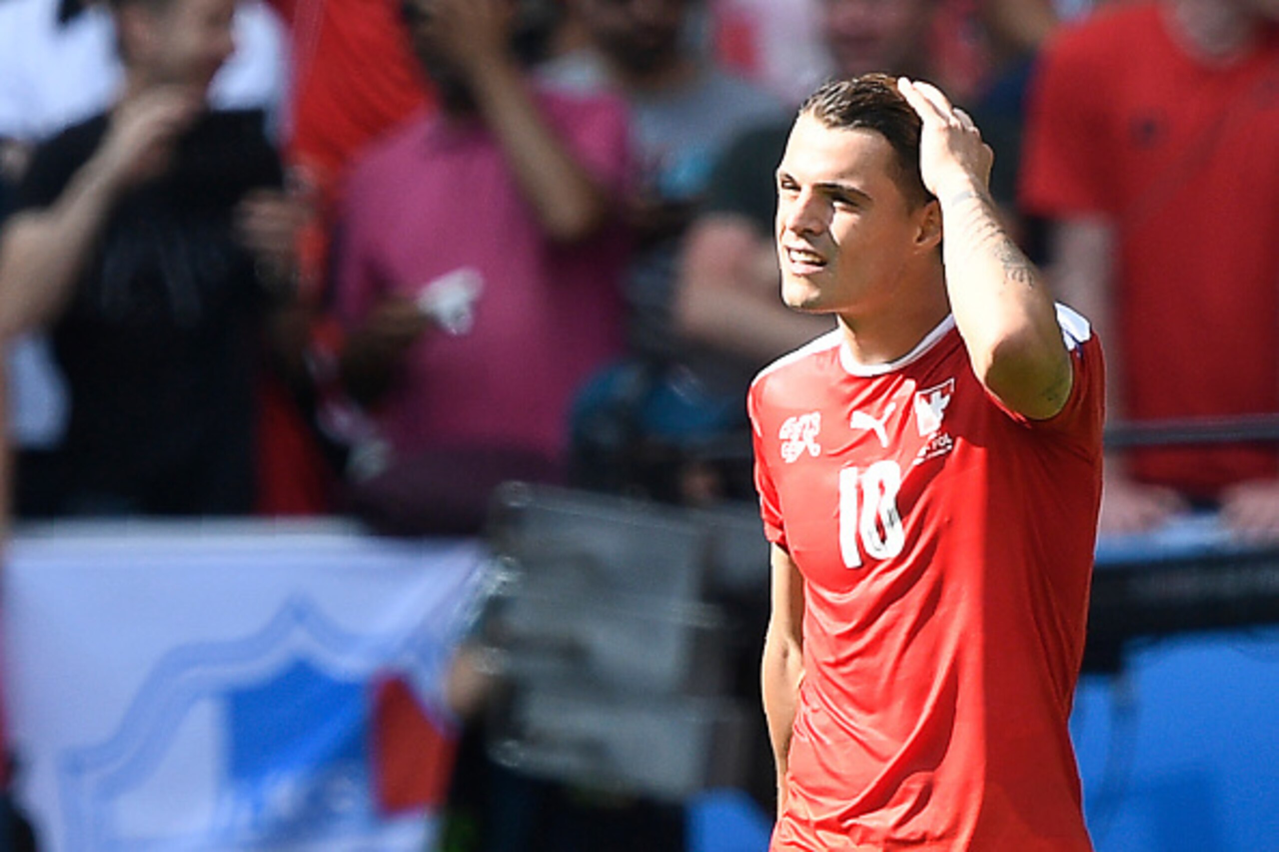 Switzerland's midfielder Granit Xhaka reacts after missing a penalty during the Euro 2016 round of sixteen football match Switzerland vs Poland, on June 25, 2016 at the Geoffroy Guichard stadium in Saint-Etienne. / AFP / MARTIN BUREAU        (Photo credit