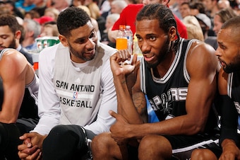PORTLAND, OR - NOVEMBER 11: Tim Duncan #21 of the San Antonio Spurs and Kawhi Leonard #2 of the San Antonio Spurs during the game on November 11, 2015 at Moda Center in Portland, Oregon. NOTE TO USER: User expressly acknowledges and agrees that, by downlo