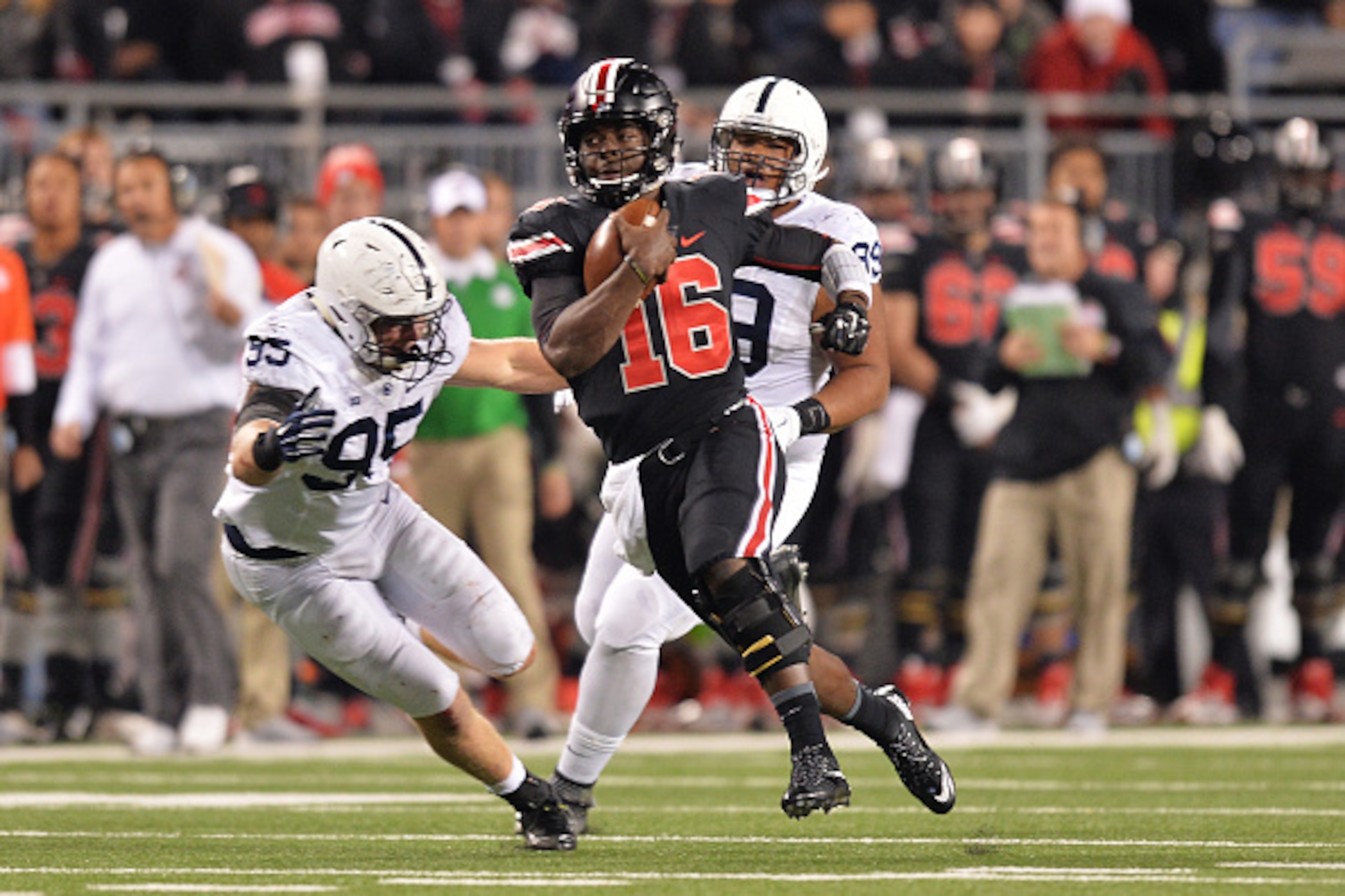 COLUMBUS, OH - OCTOBER 17:  Quarterback J.T. Barrett #16 of the Ohio State Buckeyes gains yardage in the fourth quarter as Carl Nassib #95 of the Penn State Nittany Lions moves in for the tackle at Ohio Stadium on October 17, 2015 in Columbus, Ohio. Ohio 