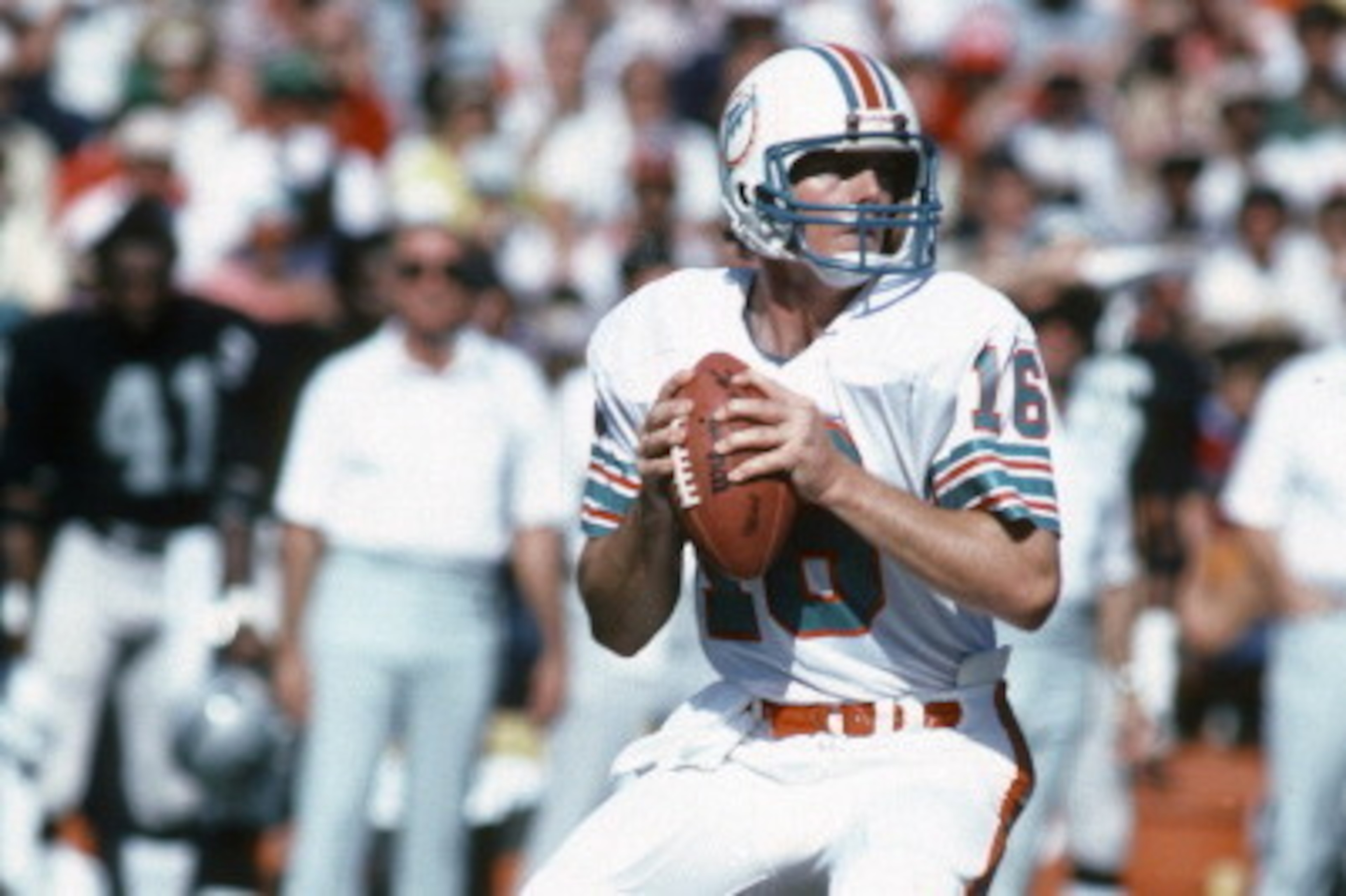 MIAMI, FL - NOVEMBER 15:   David Woodley #16 of the Miami Dolphins drops back to pass against the Oakland Raiders during an NFL football game November 15, 1981 at the Orange Bowl in Miami, Florida. Woodley played for the Dolphins from 1980-83. (Photo by F