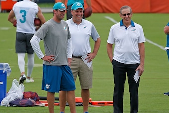 DAVIE, FL - JUNE 9: (L - R) Head coach Adam Gase, Executive Vice President of Football Operations Mike Tannenbaum, and Chairman of the Board/Managing General Partner Stephen M. Ross of the Miami Dolphins look on during the team's OTAs on June 9, 2016 at t