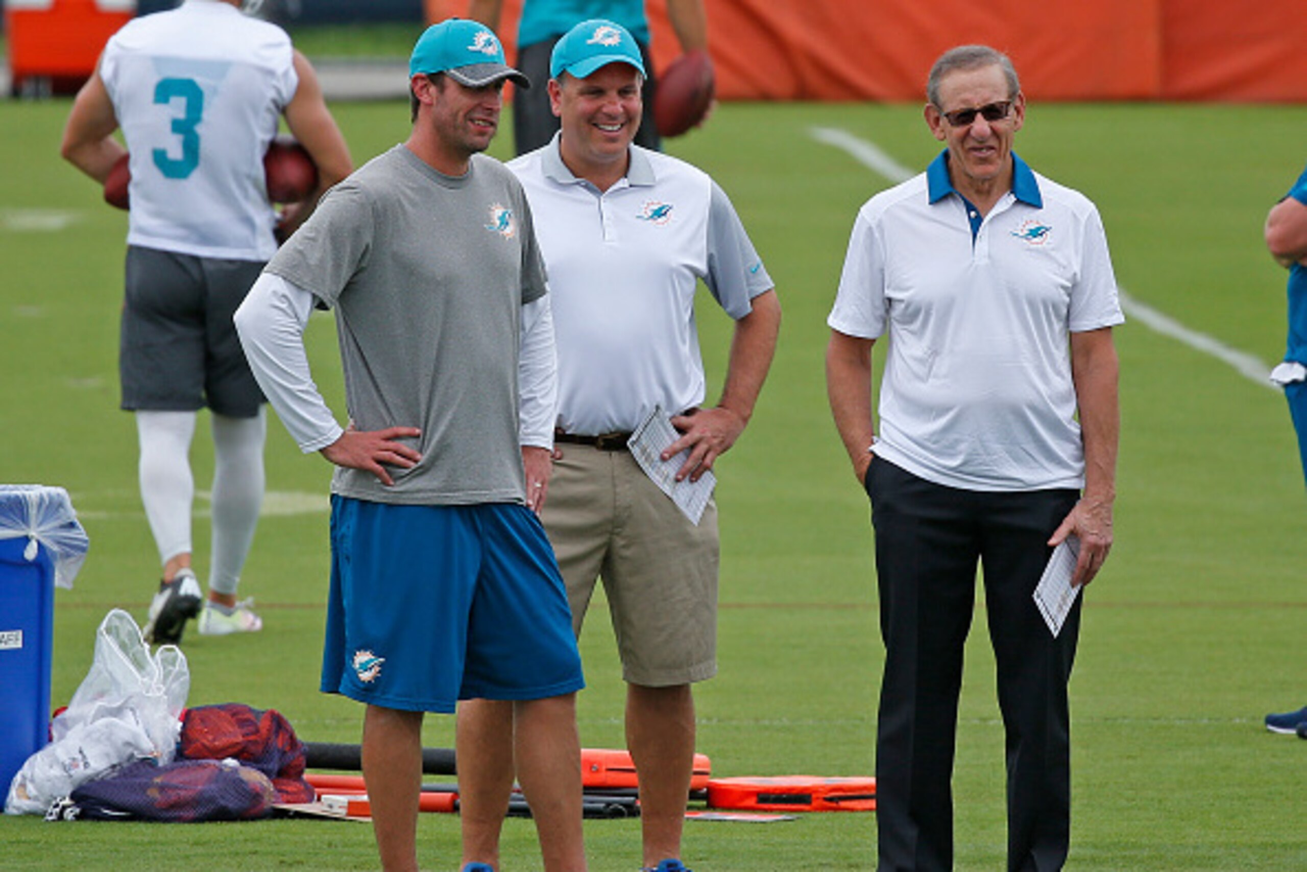 DAVIE, FL - JUNE 9: (L - R) Head coach Adam Gase, Executive Vice President of Football Operations Mike Tannenbaum, and Chairman of the Board/Managing General Partner Stephen M. Ross of the Miami Dolphins look on during the team's OTAs on June 9, 2016 at t DAVIE, FL - JUNE 9: (L - R) Head coach Adam Gase, Executive Vice President of Football Operations Mike Tannenbaum, and Chairman of the Board/Managing General Partner Stephen M. Ross of the Miami Dolphins look on during the team's OTAs on June 9, 2016 at t