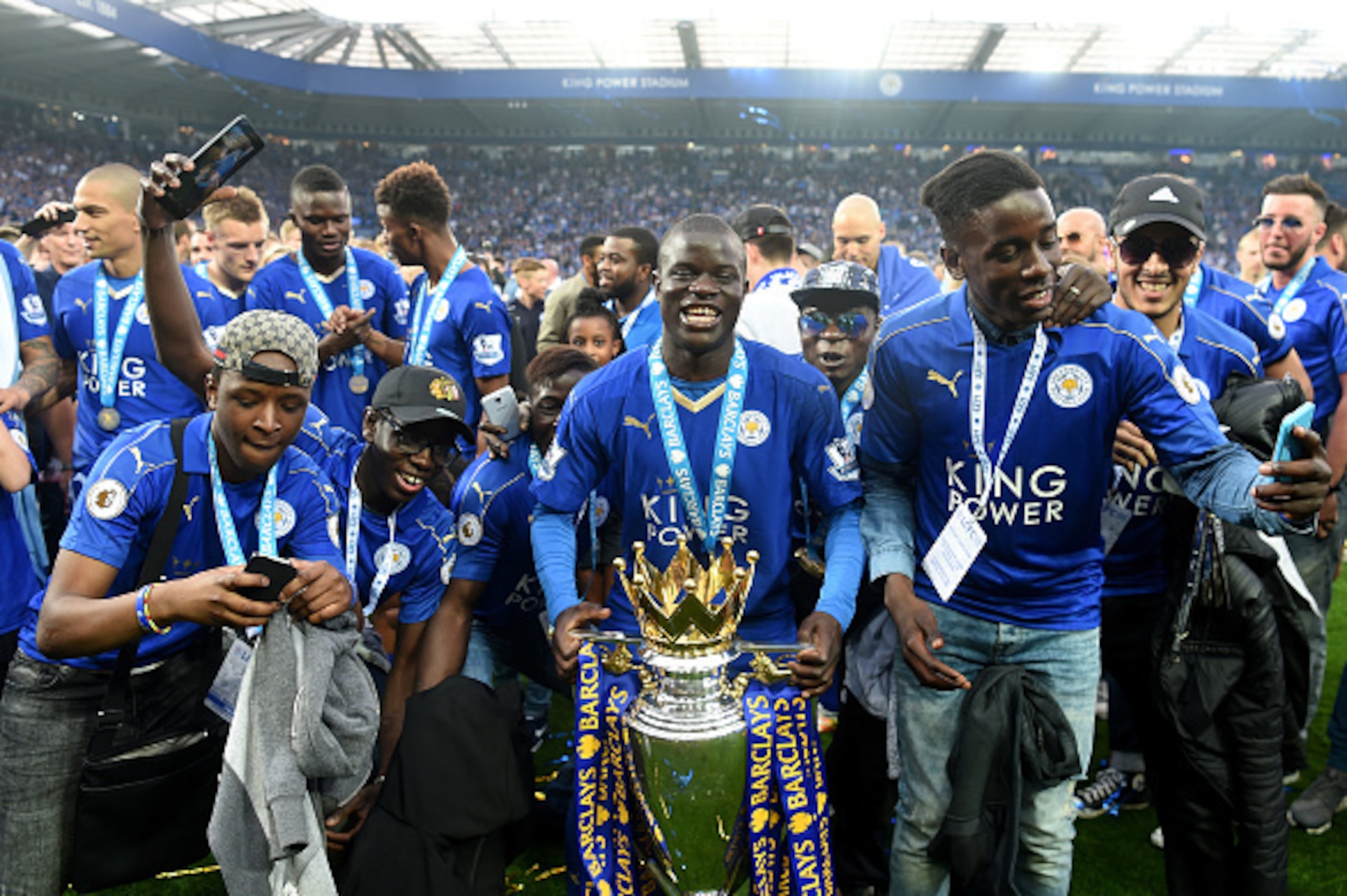 LEICESTER, ENGLAND - MAY 07:  Ngolo Kante of Leicester City poses with the Premier League Trophy with his family as players and staffs celebrate the season champion after the Barclays Premier League match between Leicester City and Everton at The King Pow