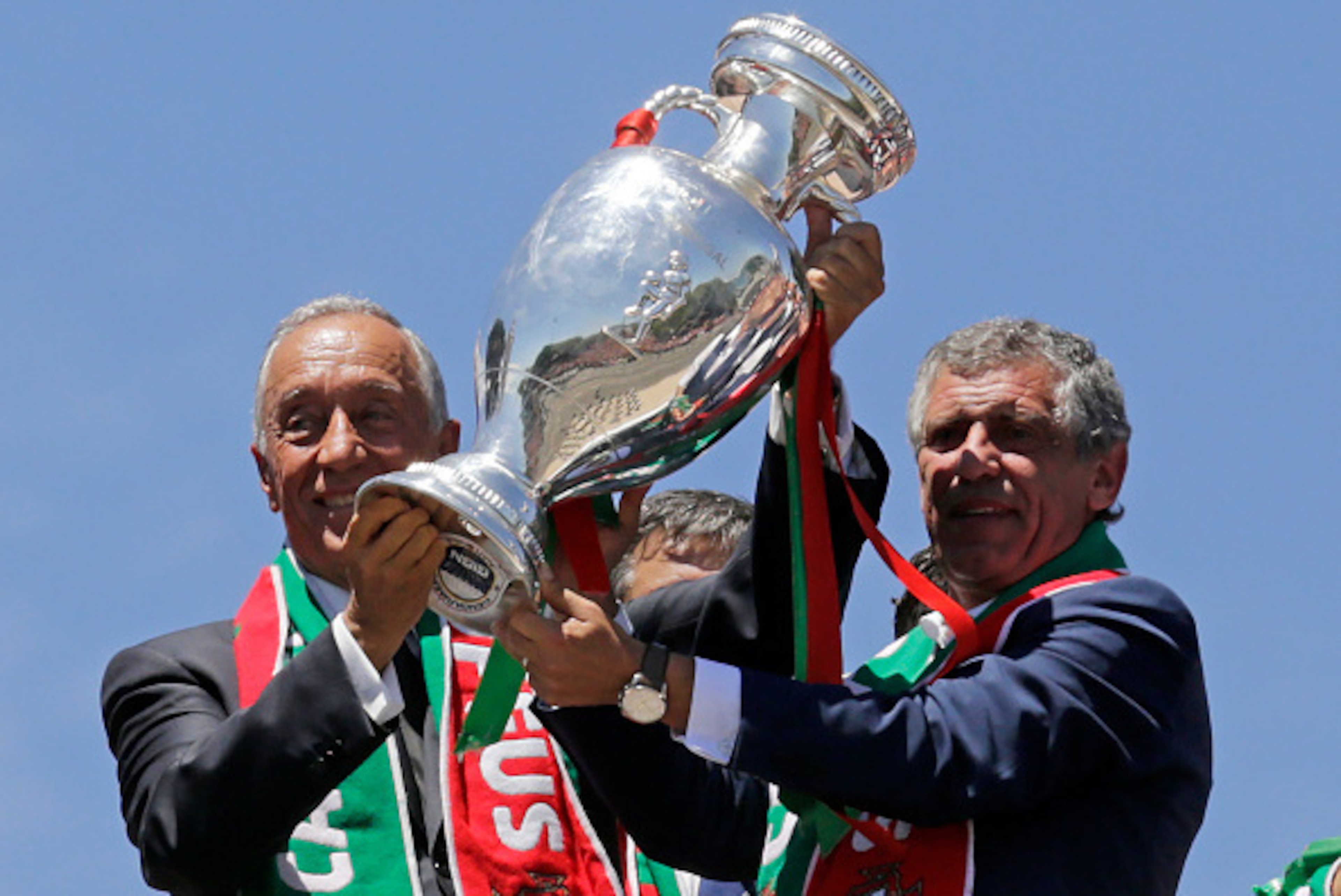 Portugal's president Marcelo Rebelo de Sousa (L) and Portugal's coach Fernando Santos hold the trophy on the balcony of the Belem Palace as they celebrate their victory on July 11, 2016 after their Euro 2016 final football win over France yesterday.
The P
