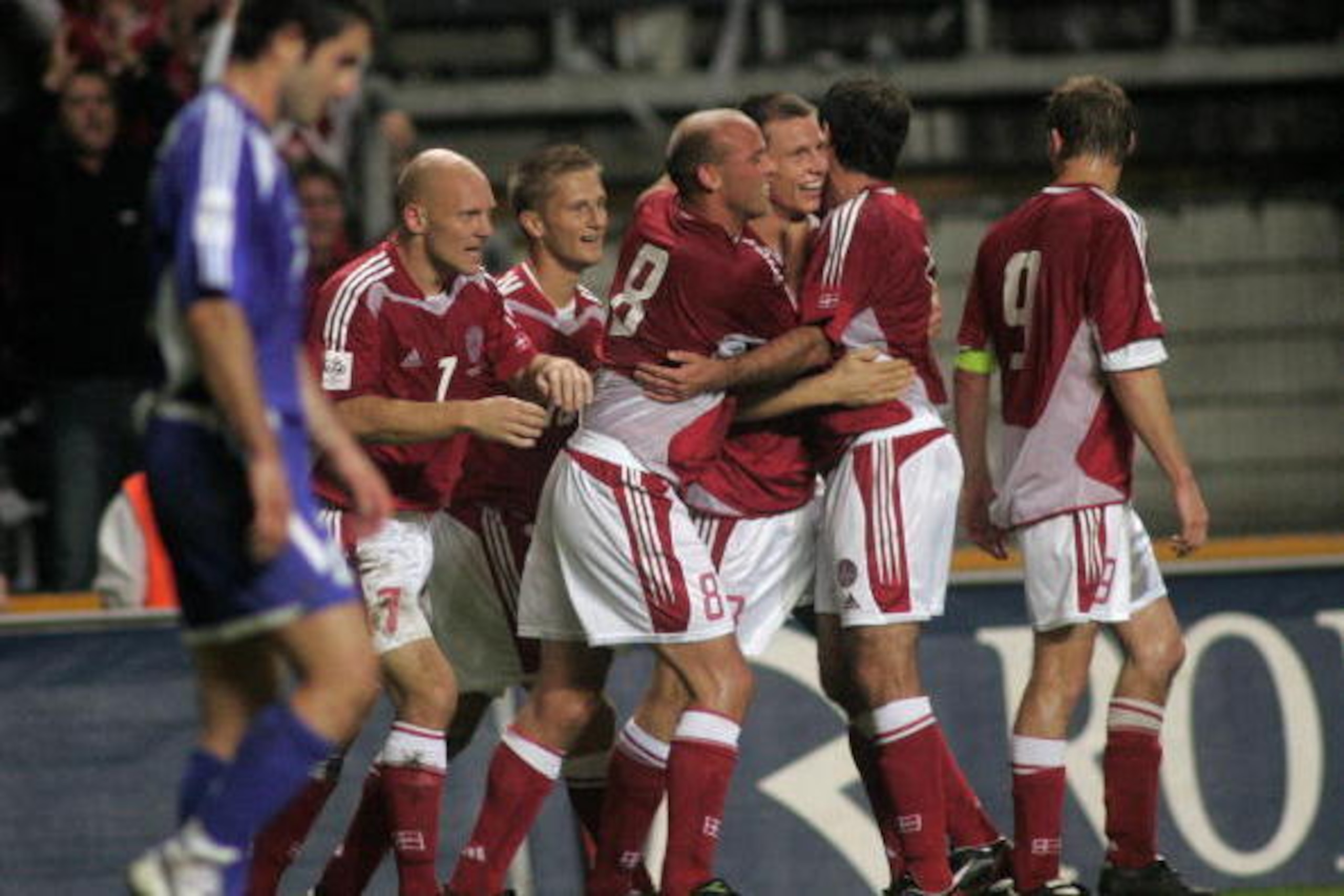 Copenhagen, DENMARK: A Greek player passes in front of jubilating Danish players - from left: Thomas Gravesen, Martin Jorgensen, Claus Jensen, Michael Gravgaard, Niclas Jensen and Jon Dahl Tomasson - after Michael Gravgaard's goal to 1-0 during the FIFA Copenhagen, DENMARK: A Greek player passes in front of jubilating Danish players - from left: Thomas Gravesen, Martin Jorgensen, Claus Jensen, Michael Gravgaard, Niclas Jensen and Jon Dahl Tomasson - after Michael Gravgaard's goal to 1-0 during the FIFA