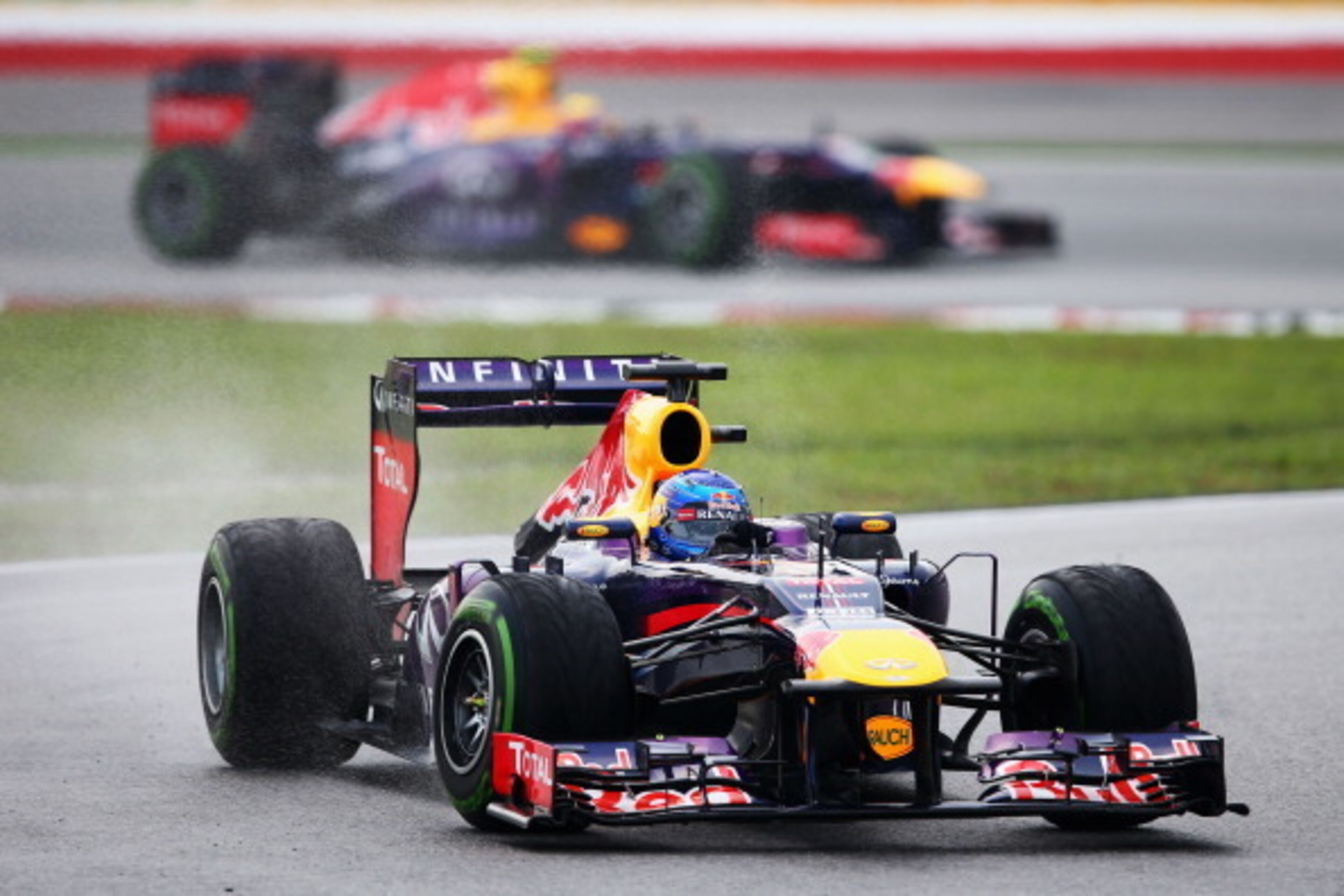 KUALA LUMPUR, MALAYSIA - MARCH 24:  Sebastian Vettel of Germany and Infiniti Red Bull Racing leads from team mate Mark Webber of Australia and Infiniti Red Bull Racing during the Malaysian Formula One Grand Prix at the Sepang Circuit on March 24, 2013 in 
