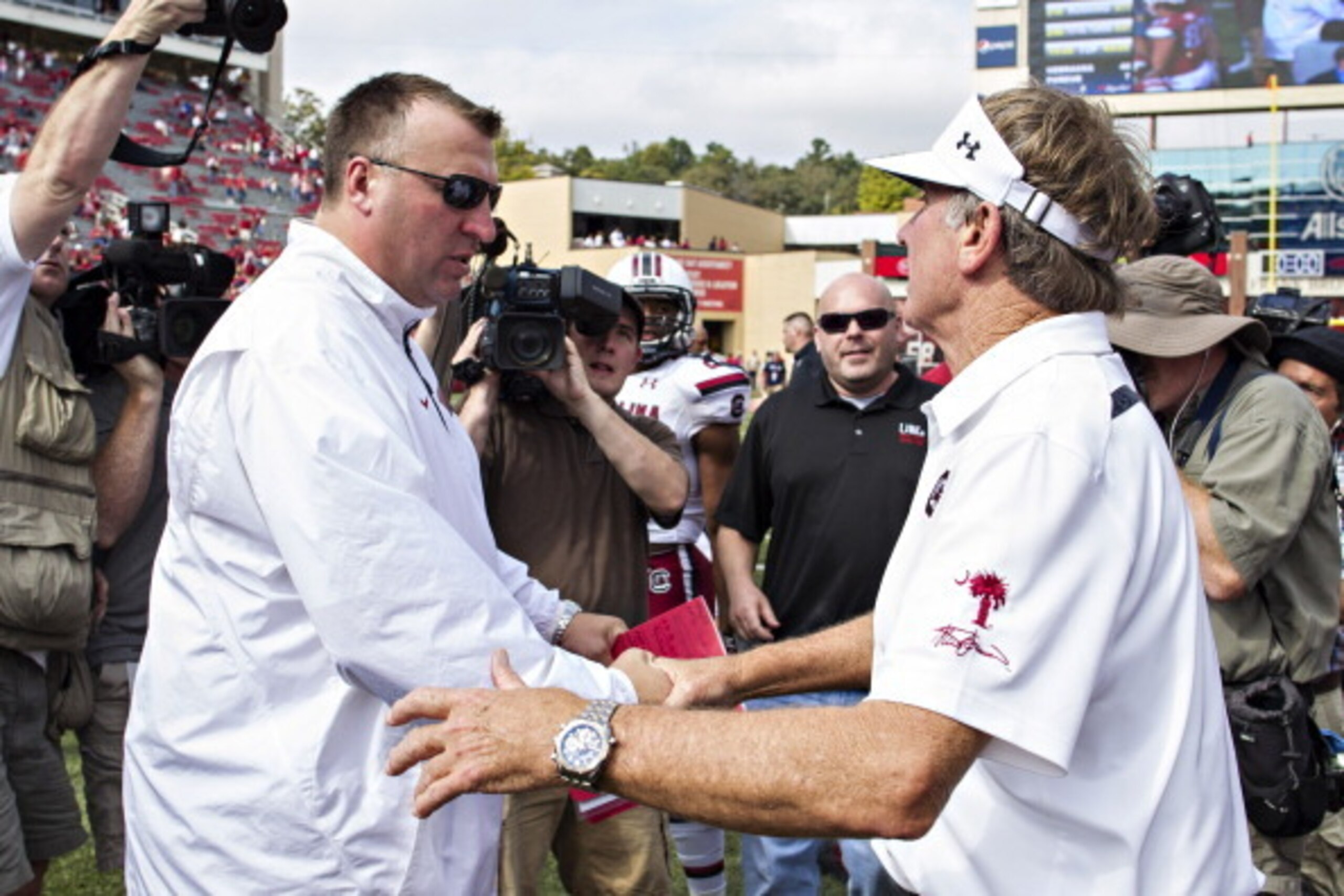 FAYETTEVILLE, AR - OCTOBER 12: Head Coach Steve Spurrier of the South Carolina Gamecocks shakes hands with Head Coach Bret Bielema of the Arkansas Razorbacks at Razorback Stadium on October 12, 2013 in Fayetteville, Arkansas. The Gamecocks defeated the Ra