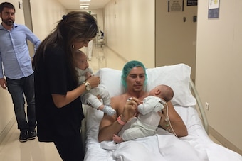 Kuric and wife Taraneh spend time with their twin children at the hospital before a procedure.