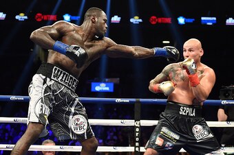 Deontay Wilder (L) of the US extends a left against Artur Szpilka of Poland during their WBC Heavyweight Championship bout at Barclay's Center in Brooklyn, New York, on January 16, 2016. 
Wilder knocked out Szpilka in the ninth round.  / AFP / AFP PHOTO /
