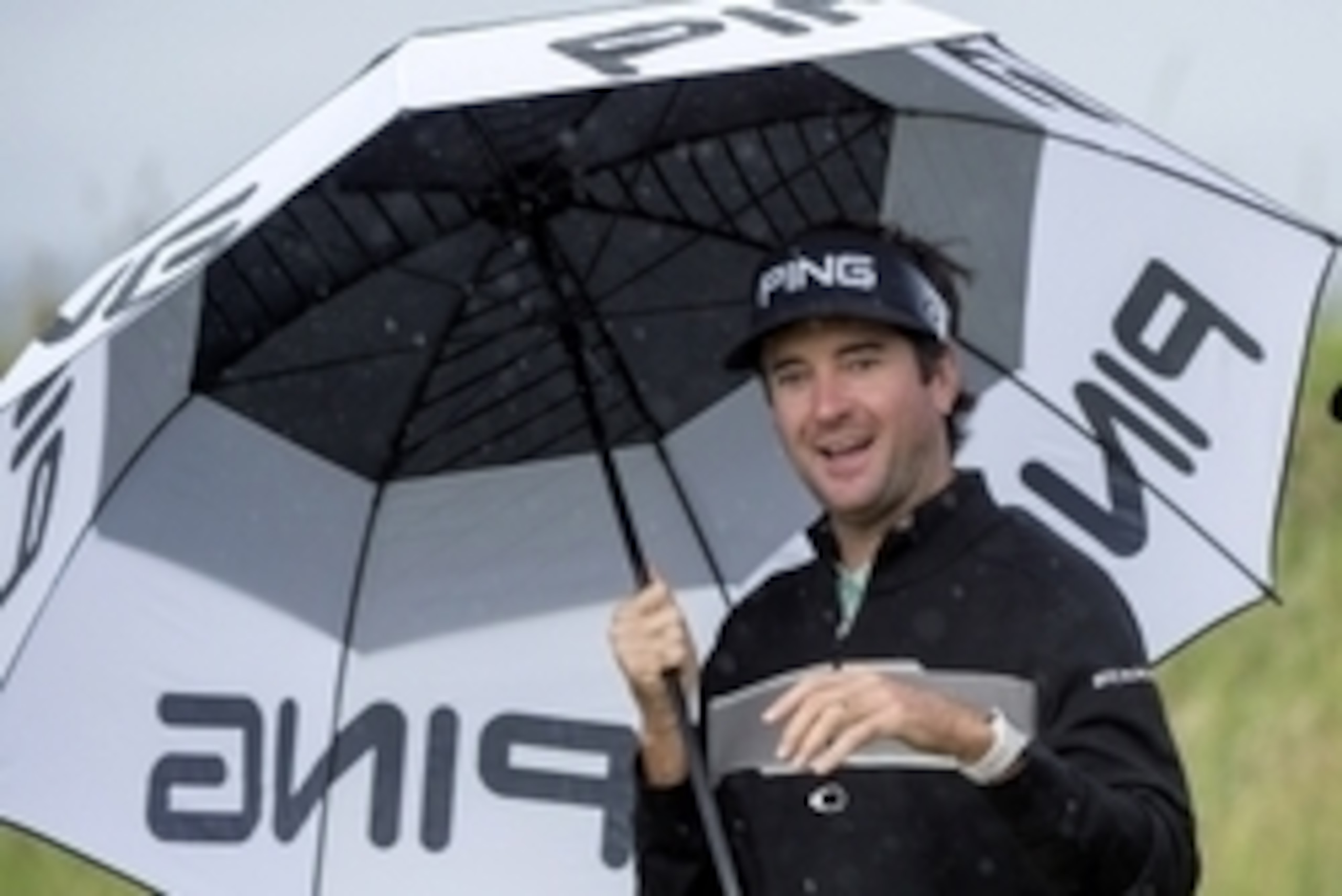 Jul 13, 2016; Ayrshire,  SCT;  Bubba Watson (USA) shelters under an umbrella during a practice round for the 145th Open Championship golf tournament at Royal Troon Golf Club - Old Course. Mandatory Credit: Ian Rutherford-USA TODAY Sports