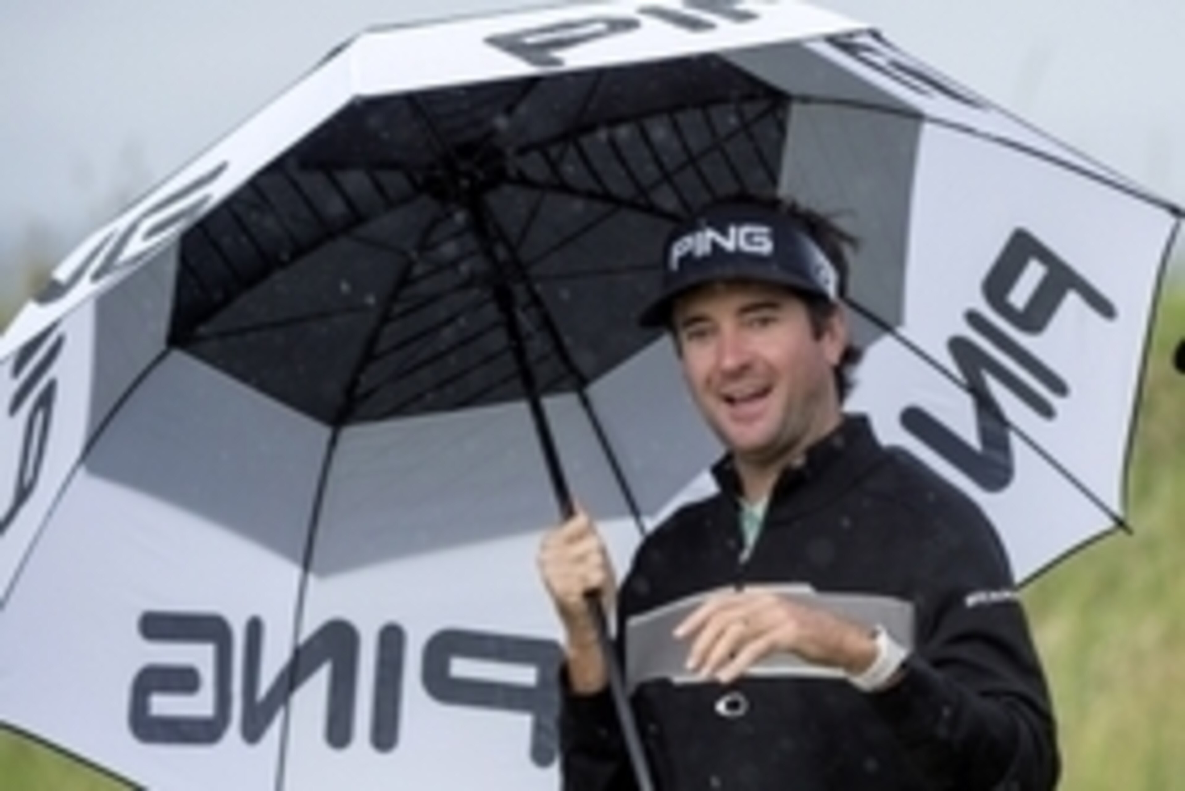 Jul 13, 2016; Ayrshire,  SCT;  Bubba Watson (USA) shelters under an umbrella during a practice round for the 145th Open Championship golf tournament at Royal Troon Golf Club - Old Course. Mandatory Credit: Ian Rutherford-USA TODAY Sports