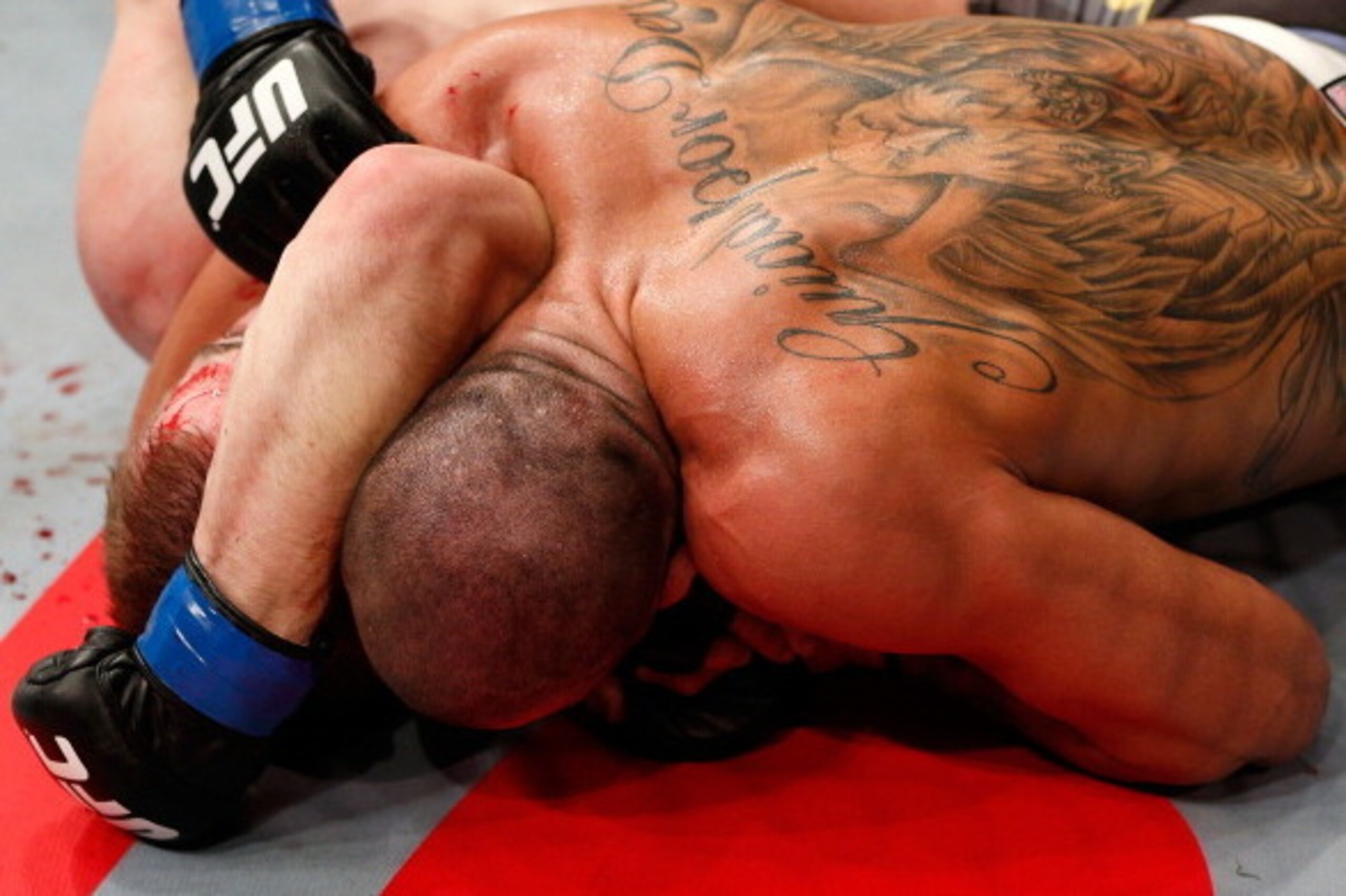 LONDON, ENGLAND - FEBRUARY 16:  (R-L) Renan Barao secures an arm triangle choke submission to defeat Michael McDonald in their interim bantamweight title fight during the UFC on Fuel TV event on February 16, 2013 at Wembley Arena in London, England.  (Pho