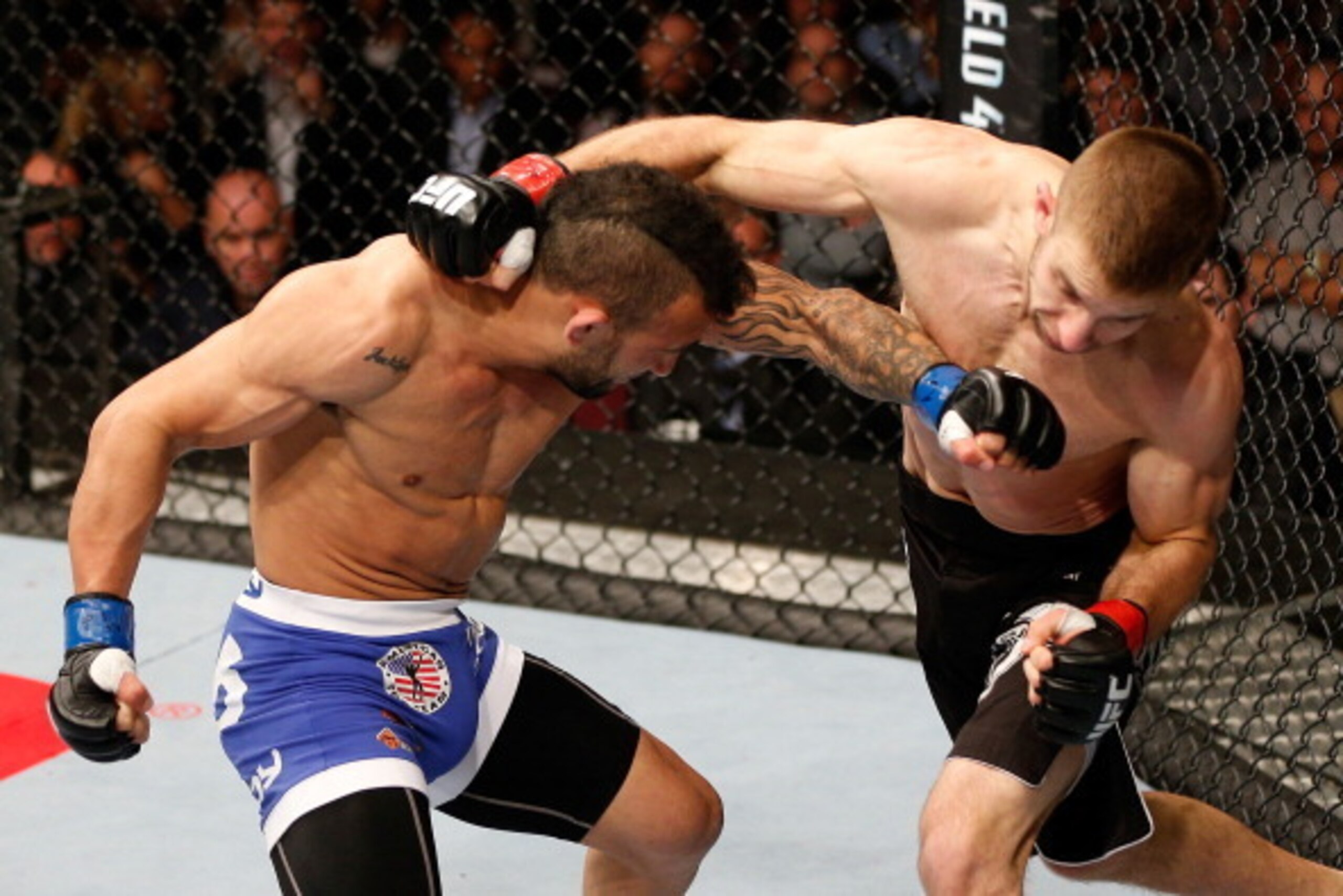 MANCHESTER, ENGLAND - OCTOBER 26:  (L-R) John Lineker punches Phil Harris in their flyweight bout during the UFC Fight Night event at Phones 4 U Arena on October 26, 2013 in Manchester, England. (Photo by Josh Hedges/Zuffa LLC/Zuffa LLC via Getty Images)
