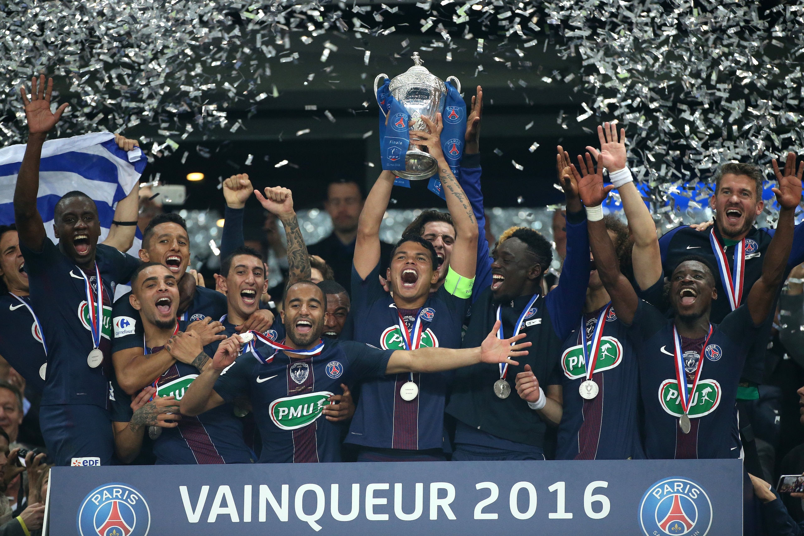 PARIS, FRANCE - MAY 21: Thiago Silva of PSG holds the French Cup surrounded by teammates Blaise Matuidi, Layvin Kurzawa, Marquinhos, Angel Di Maria, Lucas Moura, Jean-Kevin Augustin, Serge Aurier, Nicolas Douchez during the trophy ceremony following the F