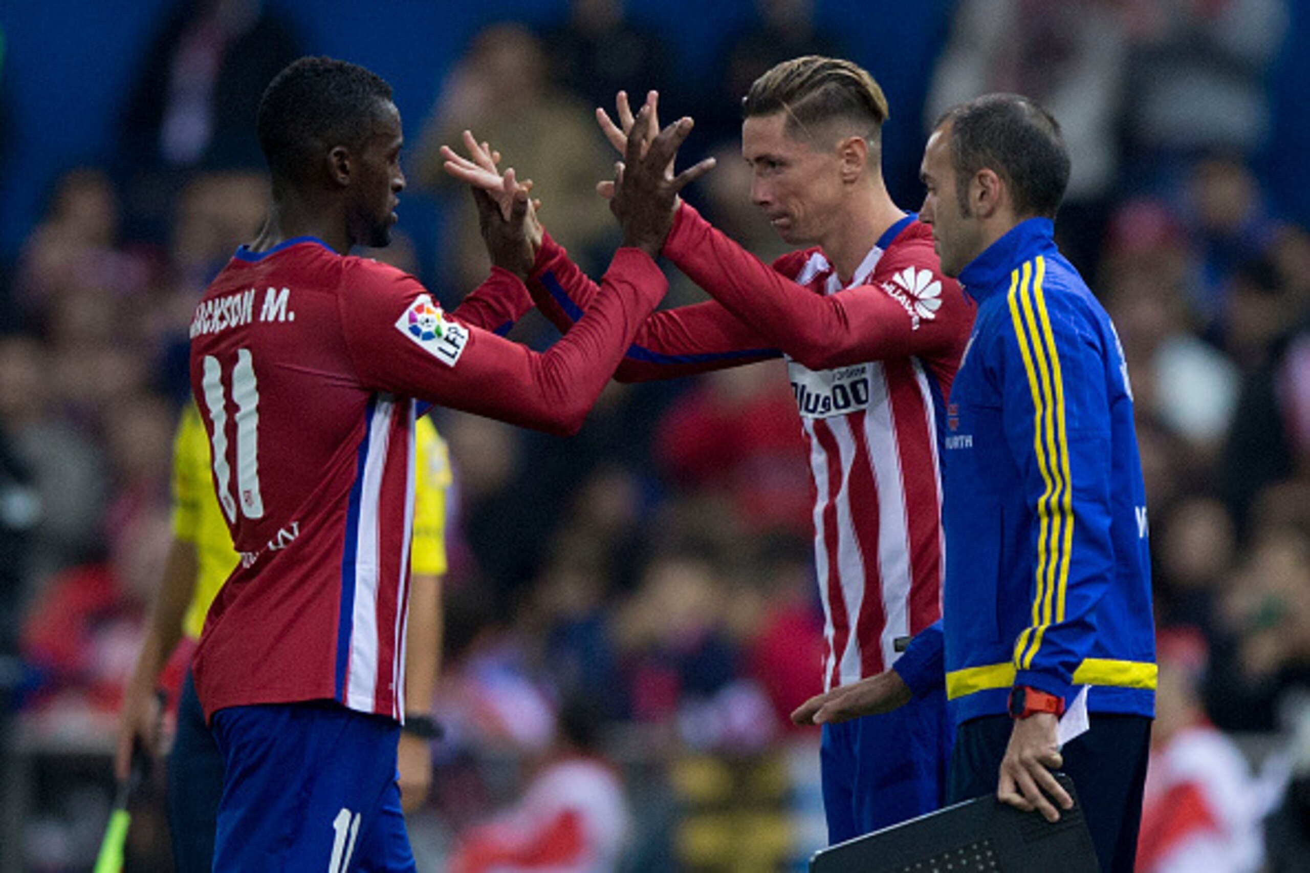 MADRID, SPAIN - OCTOBER 25: Jackson Arley Martinez  (L) of Atletico de Madrid clashes hands with Fernando Torres (R) as the first is relevated during the La Liga amtch between Club Atletico de Madrid and Valencia CF at Vicente Calderon Stadium on October 