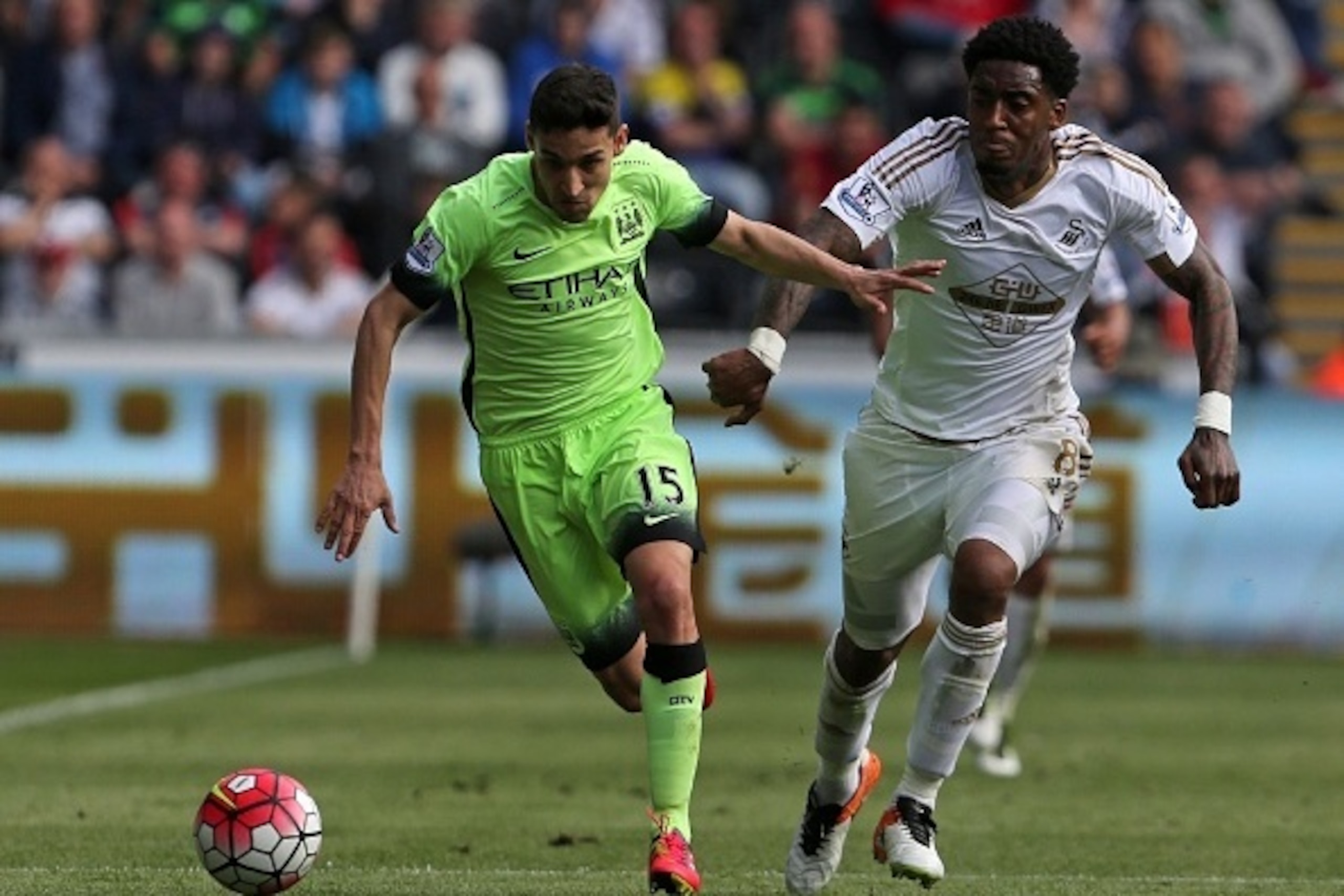 Manchester City's Spanish midfielder Jesus Navas (L) vies with Swansea City's Dutch midfielder Leroy Fer during the English Premier League football match between Swansea City and Manchester City at The Liberty Stadium in Swansea, south Wales on May 15, 20