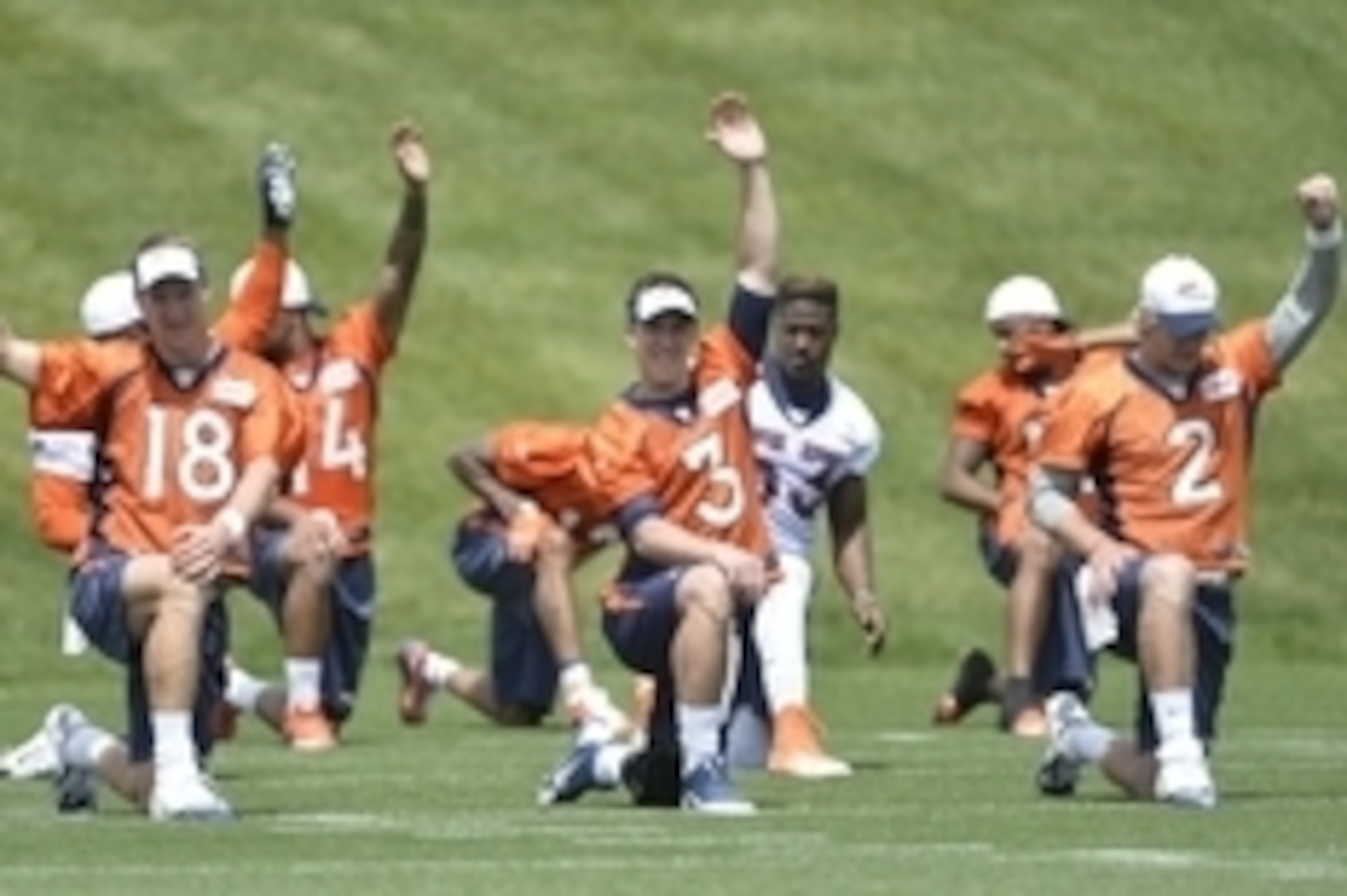 June 9, 2015; Englewood, CO, USA; Denver Broncos quarterback Peyton Manning (18) and quarterback  Trevor Siemian (3) and quarterback Zac Dysert (2) warm up before the start of mini camp activities at the Broncos training facility. Mandatory Credit: Ron Ch