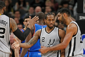 SAN ANTONIO,TX - MARCH 12: Tim Duncan #21 of the San Antonio Spurs talks congratulates Kawhi Leonard #2 of the San Antonio Spurs after a basket against the Oklahoma City Thunder at AT&T Center on March 12, 2016 in San Antonio, Texas.  NOTE TO USER: User e