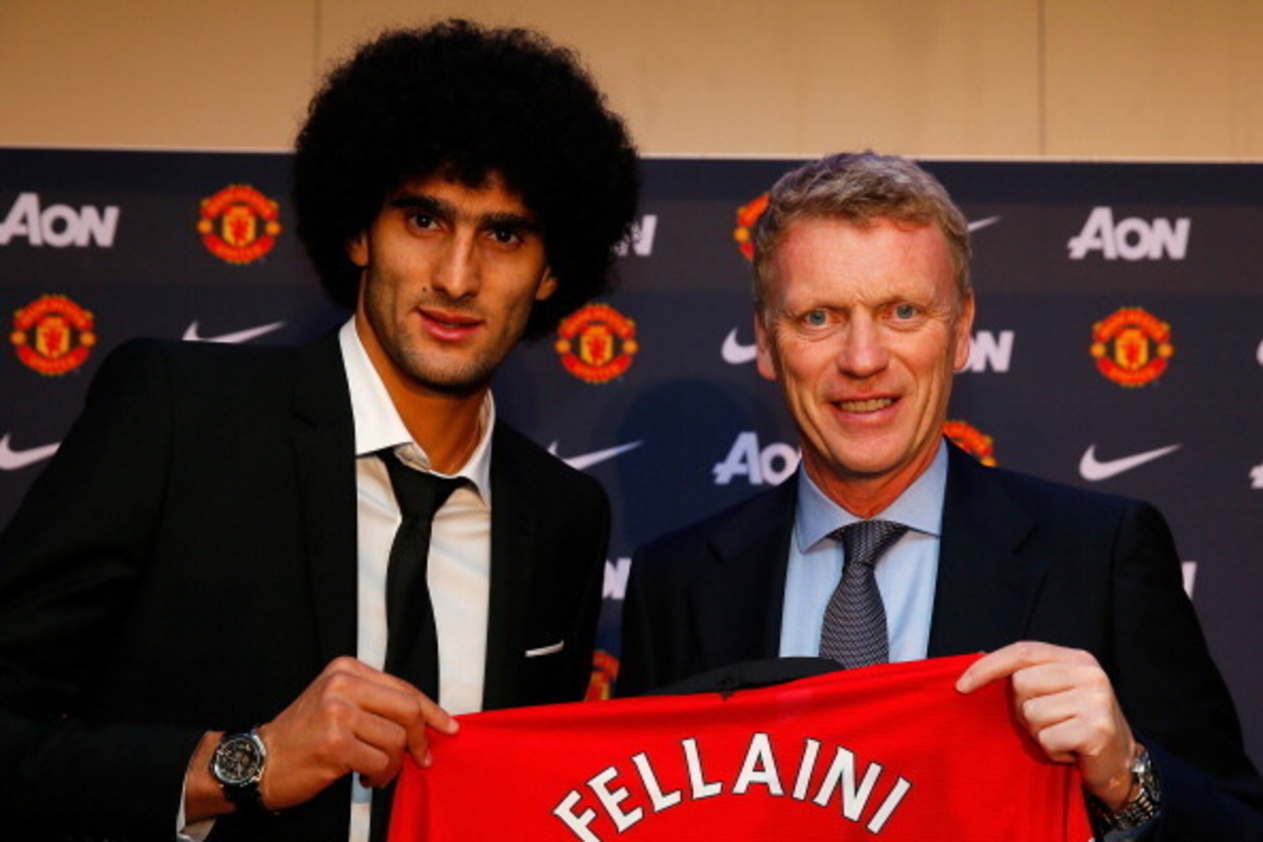 Manchester United's newly signed Belgian midfielder Marouane Fellaini (L) poses during a photocall with Manchester United's Scottish manager David Moyes at Old Trafford in Manchester, north-west England on September 13, 2013. Fellaini became Moyes first U