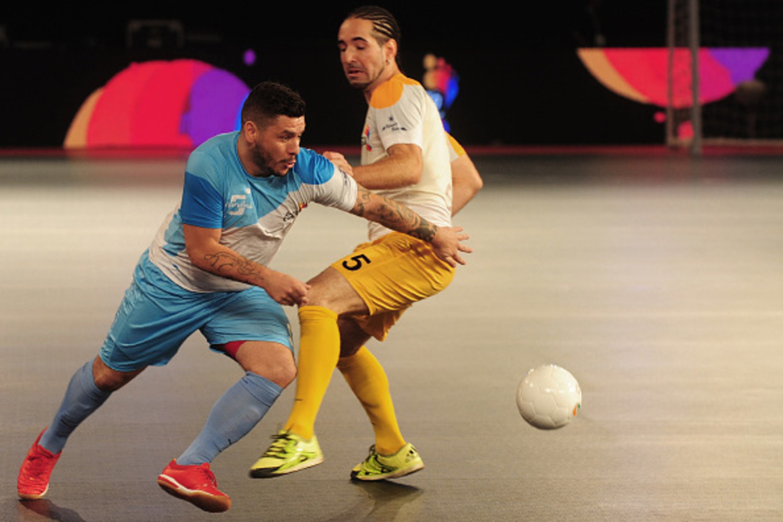 Fogila (L) from the Mumbai 5's  plays against Chennai 5's Romulu the  during their Premier Futsal Football League match in Chennai on July 15, 2016. Mumbai beat Chennai 4-2. / AFP / ARUN SANKAR        (Photo credit should read ARUN SANKAR/AFP/Getty Images
