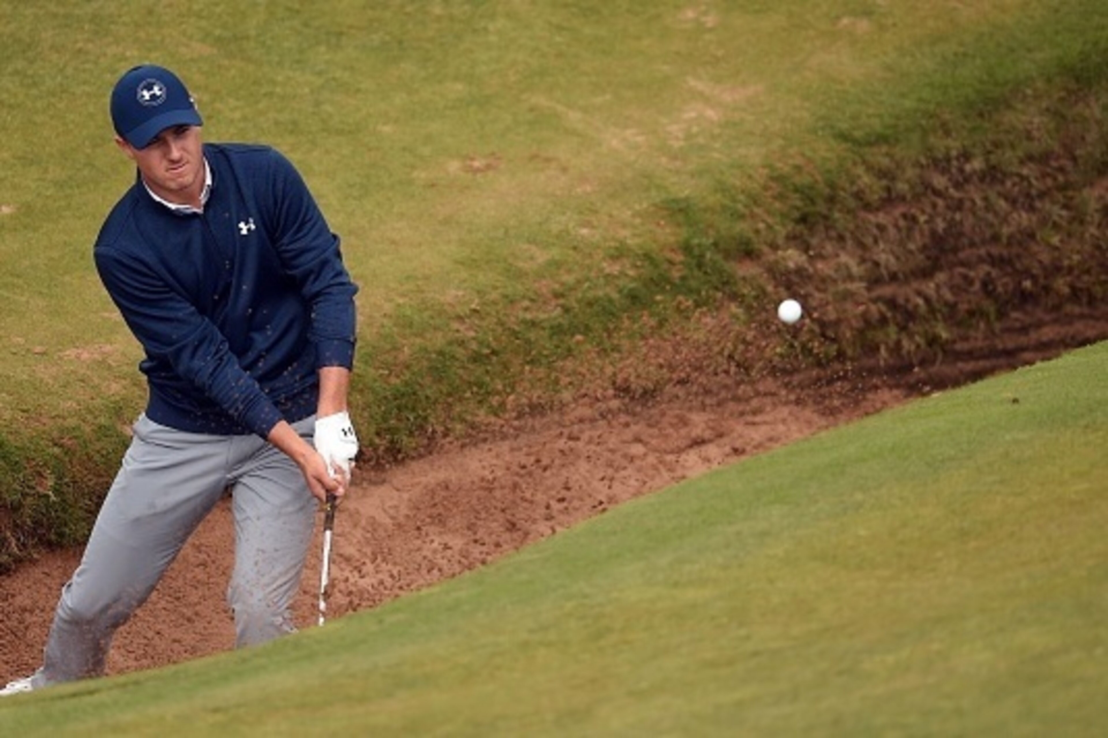 US golfer Jordan Spieth plays from a green-side bunker on the 8th hole during his second round on day two of the 2016 British Open Golf Championship at Royal Troon in Scotland on July 15, 2016.
The second round got underway on Friday morning, with expecta