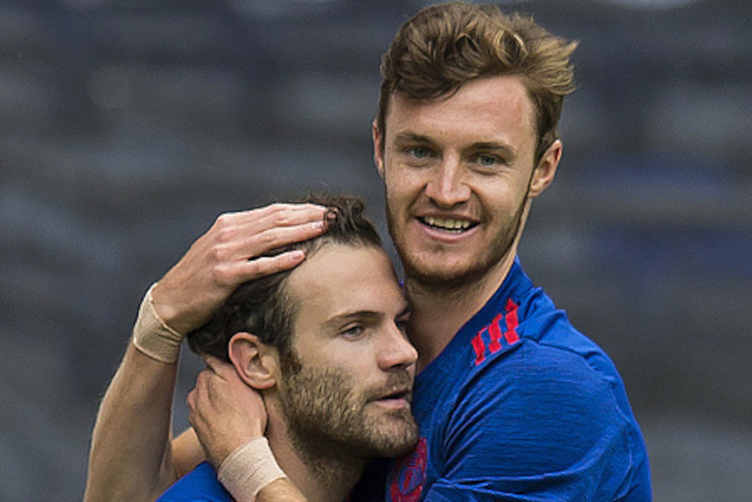 Manchester United's Spanish midfielder Juan Mata (L) and Manchester United's English striker Will Keane reacts during the pre-season friendly football match between Wigan Athletic and Manchester United at the DW stadium in Wigan, northwest England, on Jul