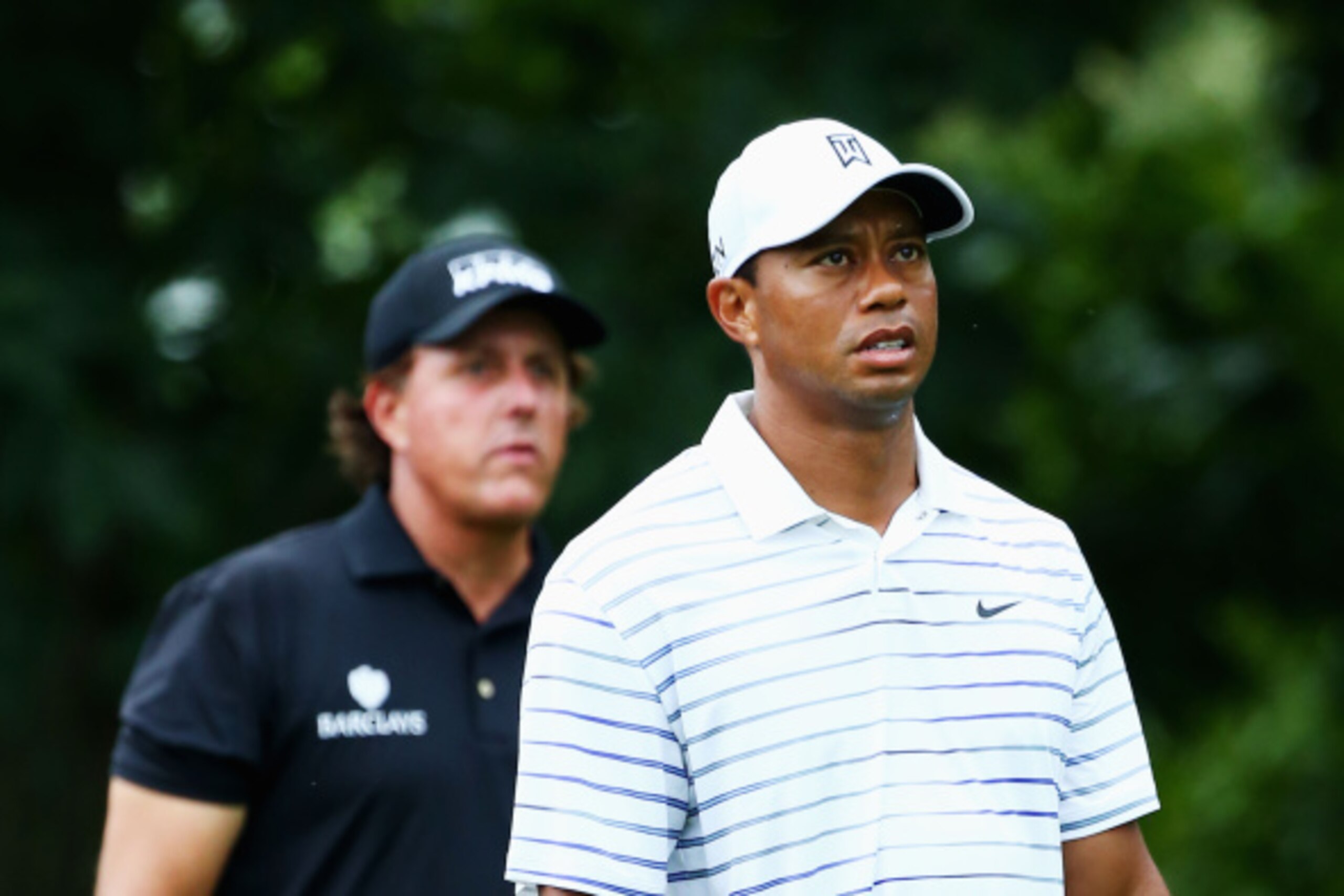 LOUISVILLE, KY - AUGUST 08:  Tiger Woods (R) of the United States and Phil Mickelson (L) of the United States walk off the 18th teen during the second round of the 96th PGA Championship at Valhalla Golf Club on August 8, 2014 in Louisville, Kentucky.  (Ph