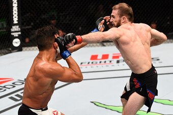 OTTAWA, ON - JUNE 18:   (R-L) Ali Bagautinov punches Geane Herrera  in their flyweight bout during the UFC Fight Night event inside the TD Place Arena on June 18, 2016 in Ottawa, Ontario, Canada. (Photo by Jeff Bottari/Zuffa LLC/Zuffa LLC via Getty Images