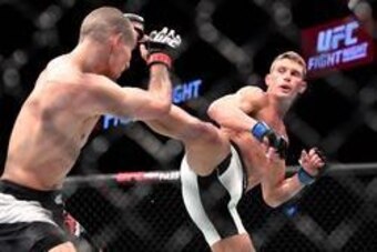 Jun 18, 2016; Ottawa, Ontario, Canada; Stephen Thompson (blue gloves) fights Rory MacDonald (red gloves) in the third round of a welterweight bout during UFC Fight Night at TD Place Arena. Mandatory Credit: Marc DesRosiers-USA TODAY Sports