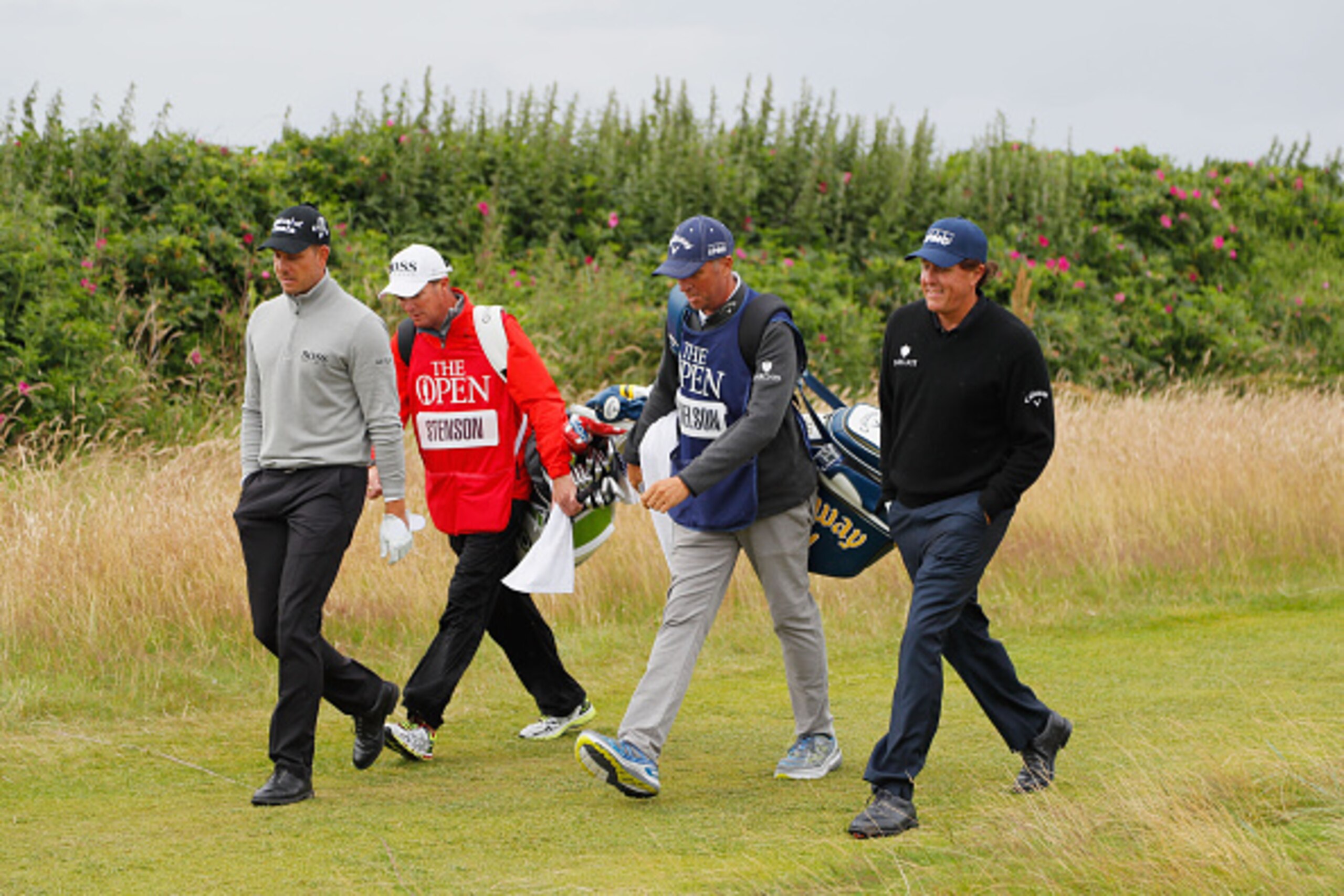 TROON, SCOTLAND - JULY 16:  Henrik Stenson of Sweden and his caddie Gareth Lord and Phil Mickelson of the United States and his caddie Jim McKay are pictured during the third round on day three of the 145th Open Championship at Royal Troon on July 16, 201