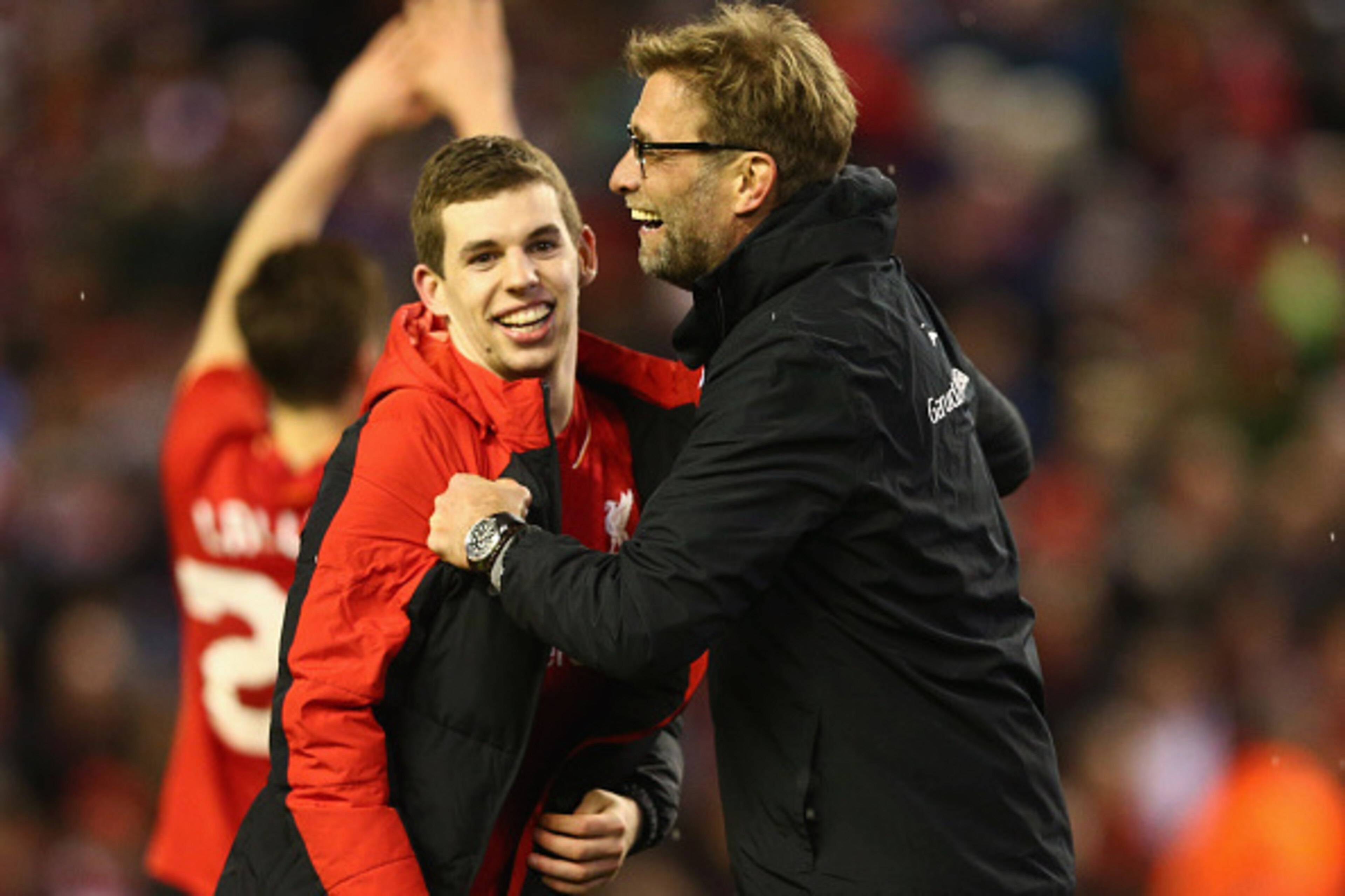 LIVERPOOL, ENGLAND - JANUARY 26:  Jurgen Klopp manager of Liverpool and Jon Flanagan of Liverpool celebrate victory in the penalty shoot out after the Capital One Cup semi final second leg match between Liverpool and Stoke City at Anfield on January 26, 2