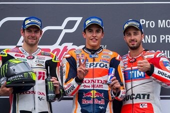 (L-R) Second placed Honda rider Cal Crutchlow of Great Britain, winner Marc Marquez of Spain and third placed Ducati rider Andrea Dovizioso of Italy pose on the podium after the MotoGP race of the Grand Prix of Germany at the Sachsenring Circuit on July 1