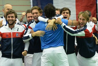 Captain of French Davis Cup team Yannick Noah (C) celebrates with teammates after Jo-Wilfried Tsonga of France won over Jiri Vesely of Czech Republic at the Davis Cup quarter-final match Czech Republic vs France on July 17, 2016 in Trinec.  / AFP / Michal