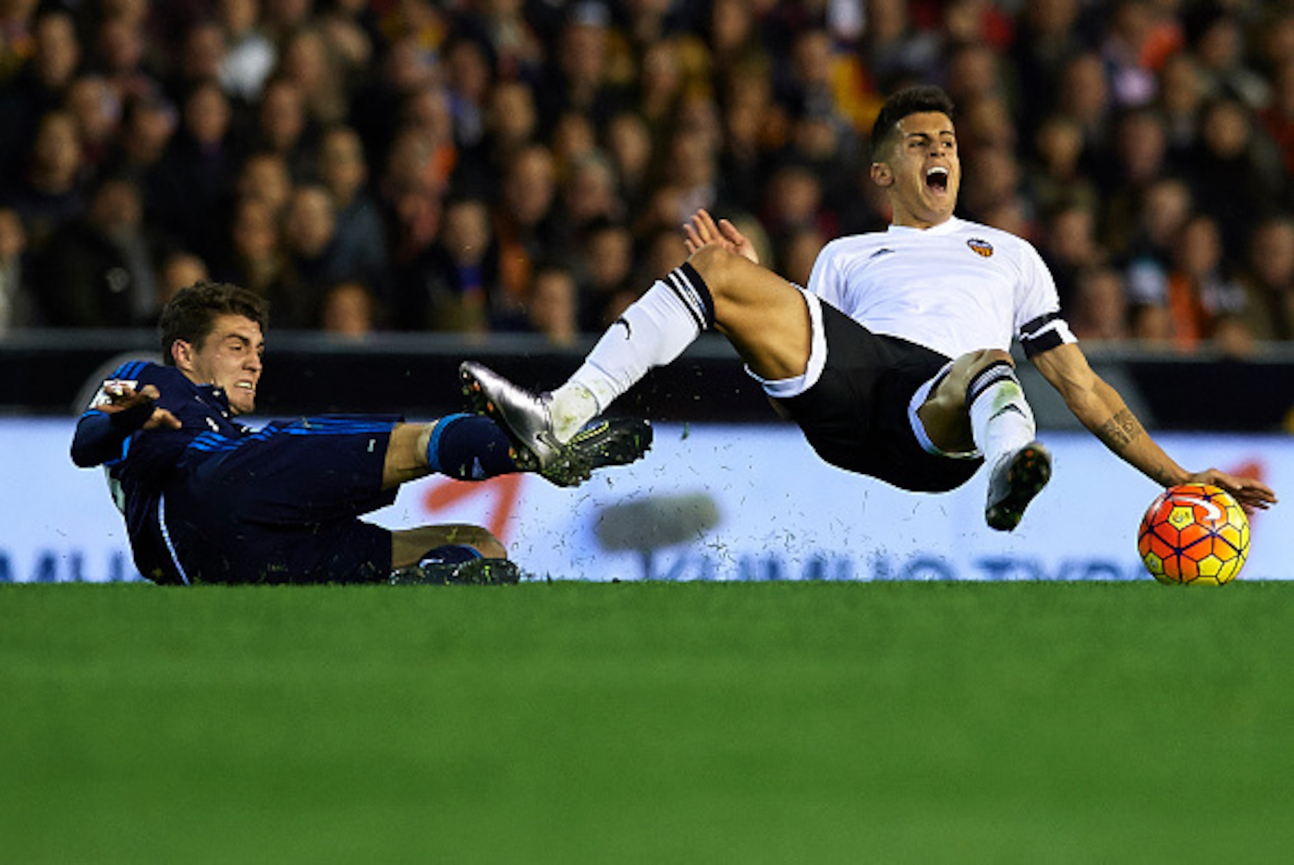 VALENCIA, SPAIN - JANUARY 03: Joao Cancelo (R) of Valencia is tackled by Mateo Kovacic of Real Madrid during the La Liga match between Valencia CF and Real Madrid CF at Estadi de Mestalla on January 03, 2016 in Valencia, Spain. (Photo by Manuel Queimade VALENCIA, SPAIN - JANUARY 03: Joao Cancelo (R) of Valencia is tackled by Mateo Kovacic of Real Madrid during the La Liga match between Valencia CF and Real Madrid CF at Estadi de Mestalla on January 03, 2016 in Valencia, Spain. (Photo by Manuel Queimade