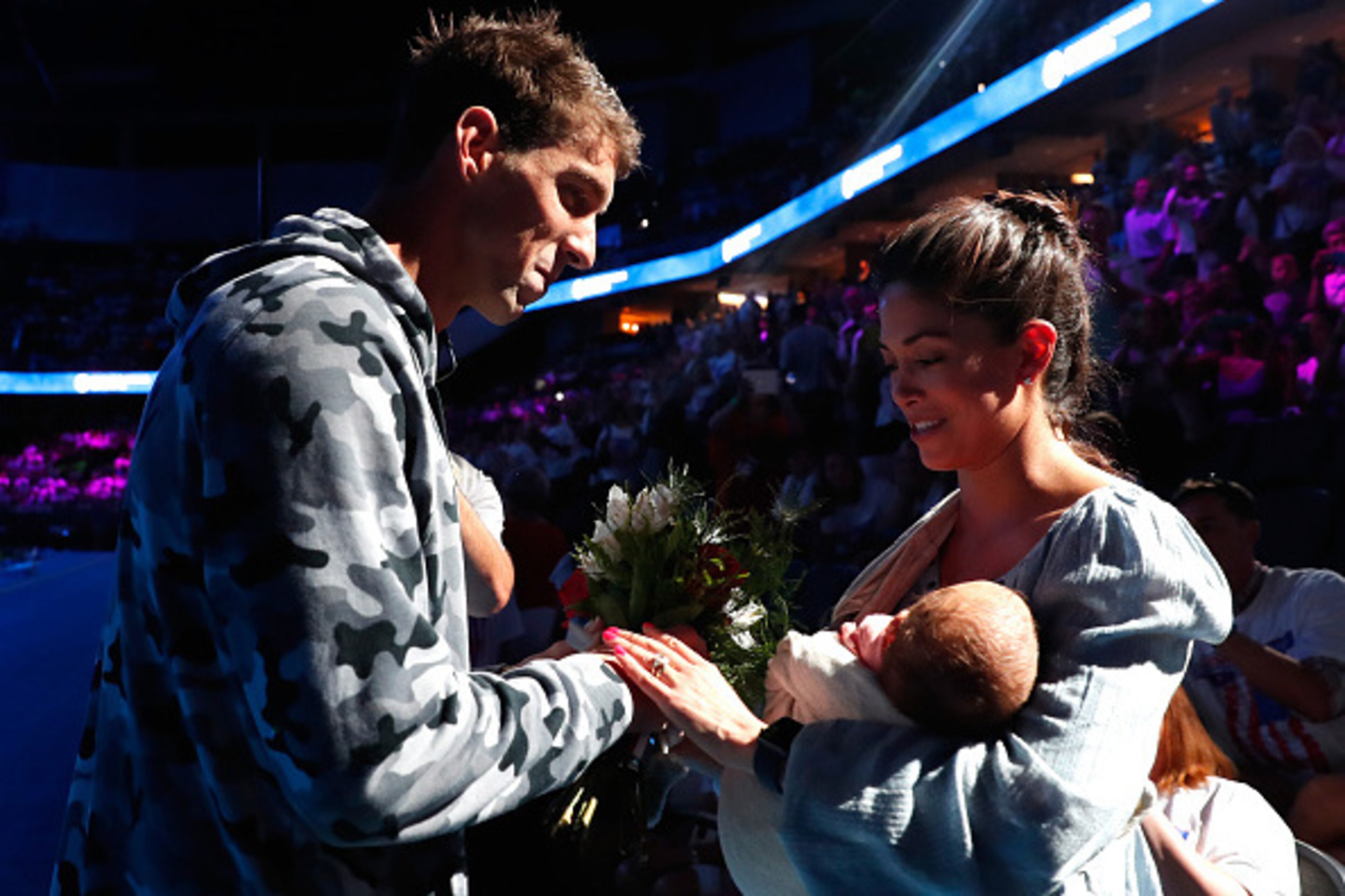 OMAHA, NE - JULY 01:  Michael Phelps (L) of the United States celebrates with his fiance Nicole Johnson (R) and their son Boomer (C) after finishing first in the final heat for the Men's 200 Meter Individual Medley during Day Six of the 2016 U.S. Olympic 