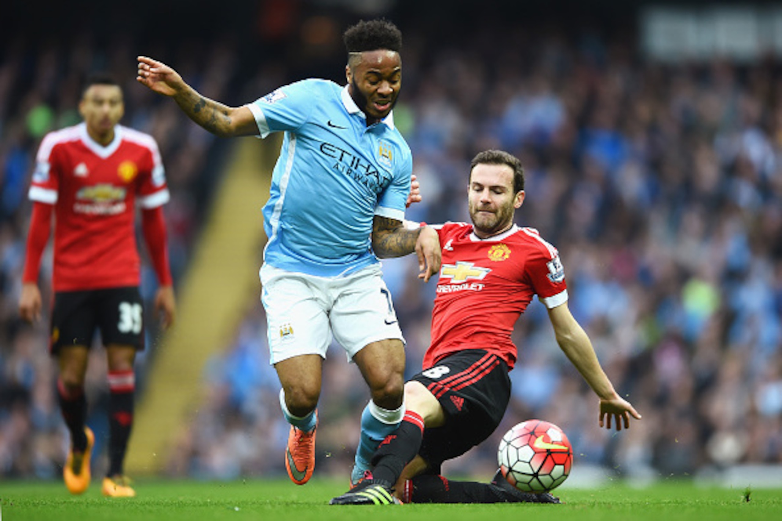MANCHESTER, ENGLAND - MARCH 20:  Raheem Sterling of Manchester City is challenged by Juan Mata of Manchester United during the Barclays Premier League match between Manchester City and Manchester United at Etihad Stadium on March 20, 2016 in Manchester, U