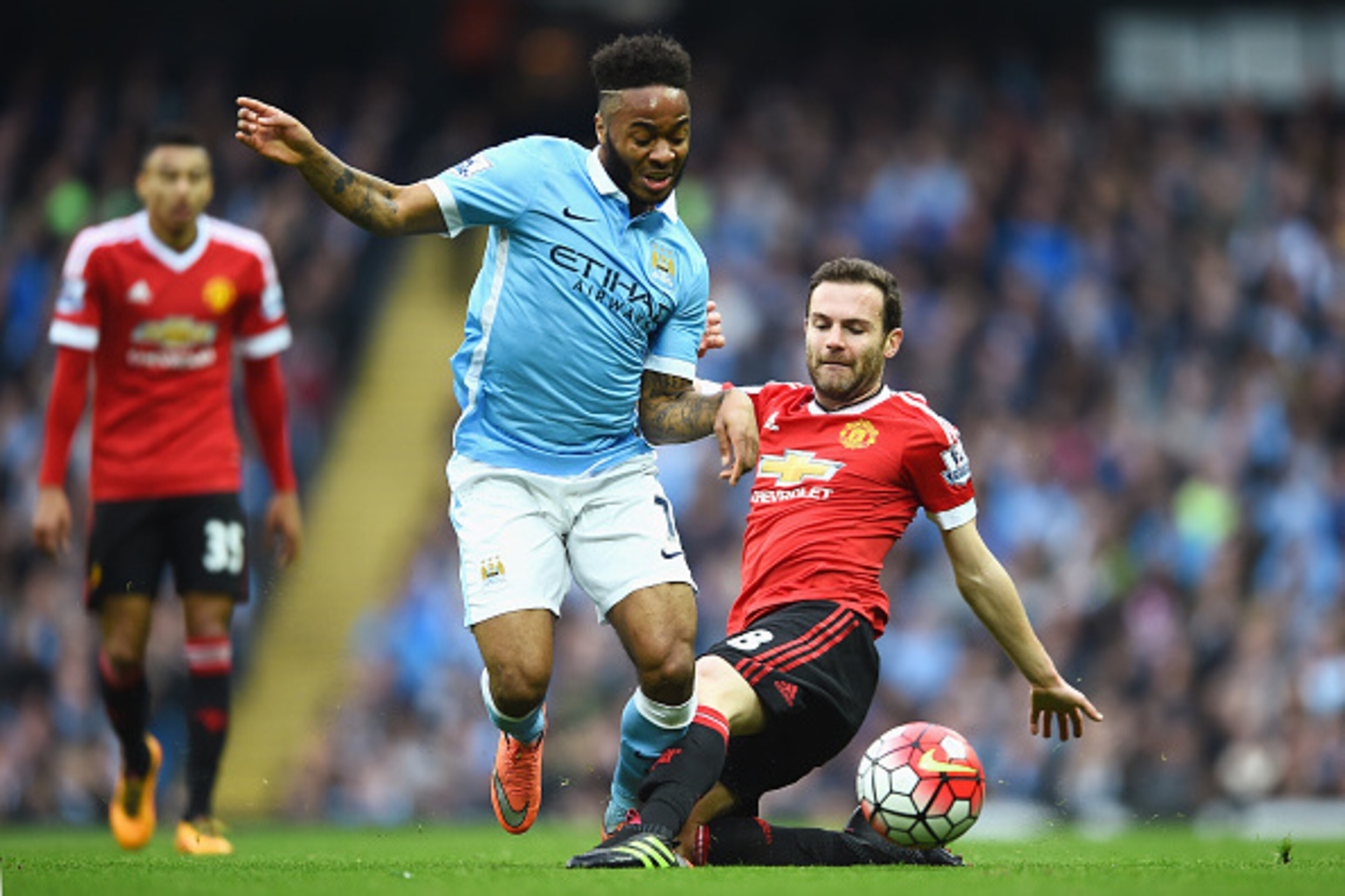 MANCHESTER, ENGLAND - MARCH 20:  Raheem Sterling of Manchester City is challenged by Juan Mata of Manchester United during the Barclays Premier League match between Manchester City and Manchester United at Etihad Stadium on March 20, 2016 in Manchester, U