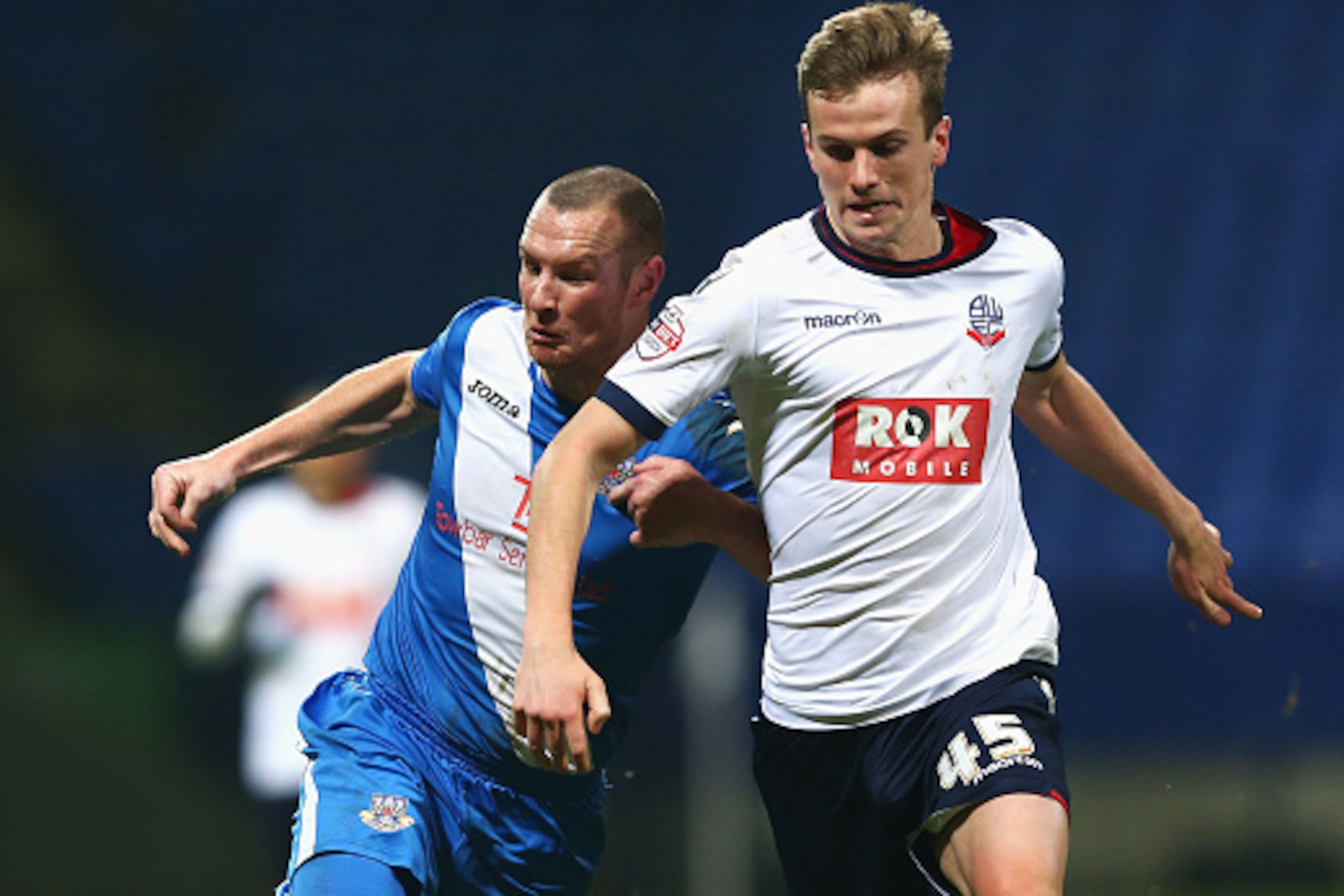 BOLTON, ENGLAND - JANUARY 19:  James Constable of Eastleigh and Rob Holding of Bolton Wanderers compete for the ball during the Emirates FA Cup Third Round Replay match between Bolton Wanderers and Eastleigh at Macron Stadium on January 19, 2016 in Bolton