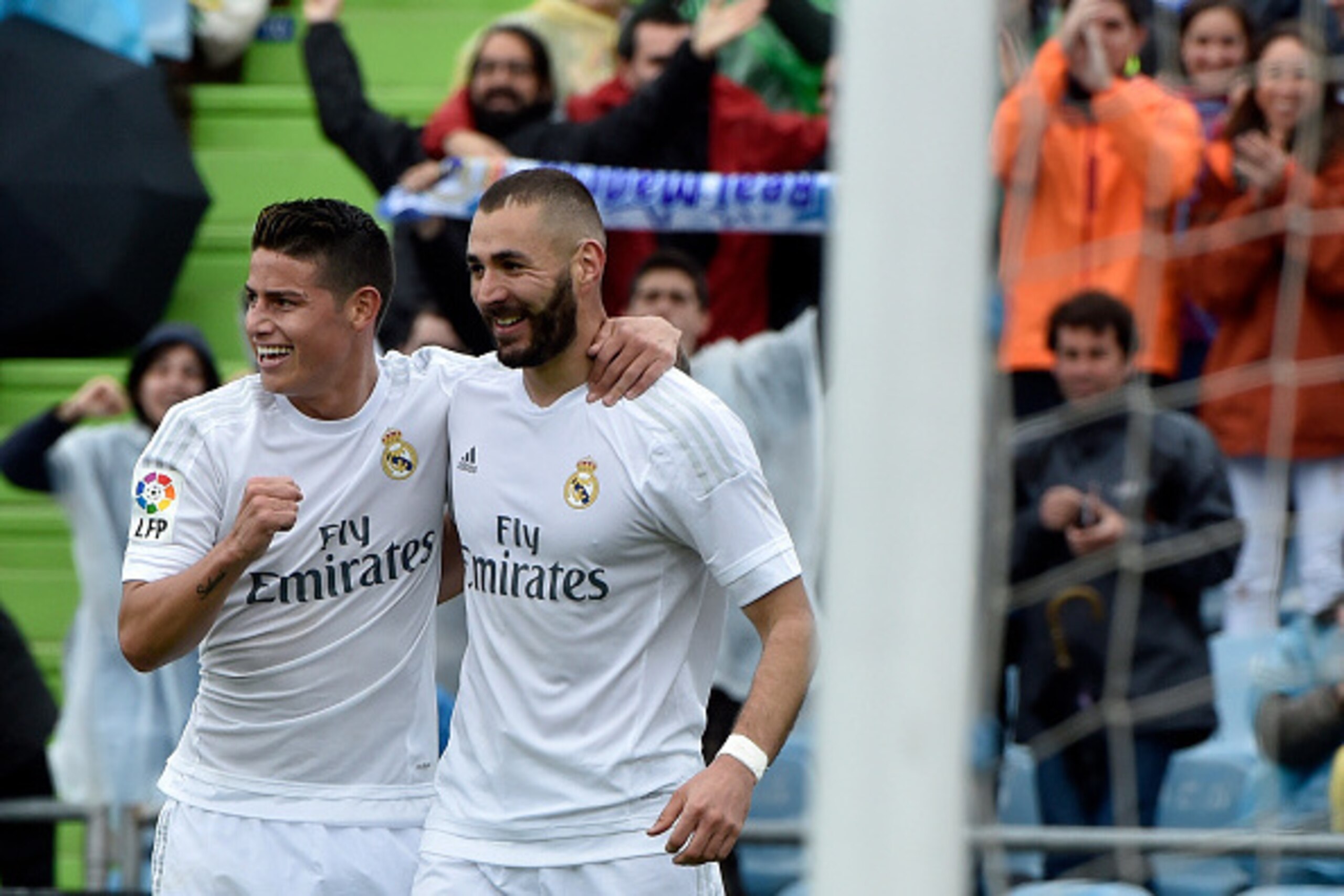 Real Madrid's French forward Karim Benzema (R) celebrates a goal with Real Madrid's Colombian midfielder James Rodriguez during the Spanish league football match Getafe CF vs Real Madrid CF at the Coliseum Alfonso Perez stadium in Getafe on April 16, 2016
