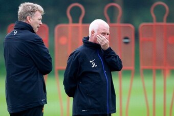 MANCHESTER, ENGLAND - OCTOBER 01: Manager David Moyes and first team coach Jimmy Lumsden (R) of Manchester United watch players in action during a training session ahead of their Champions League Group A match against Shakhtar Donetsk at their Carrington 