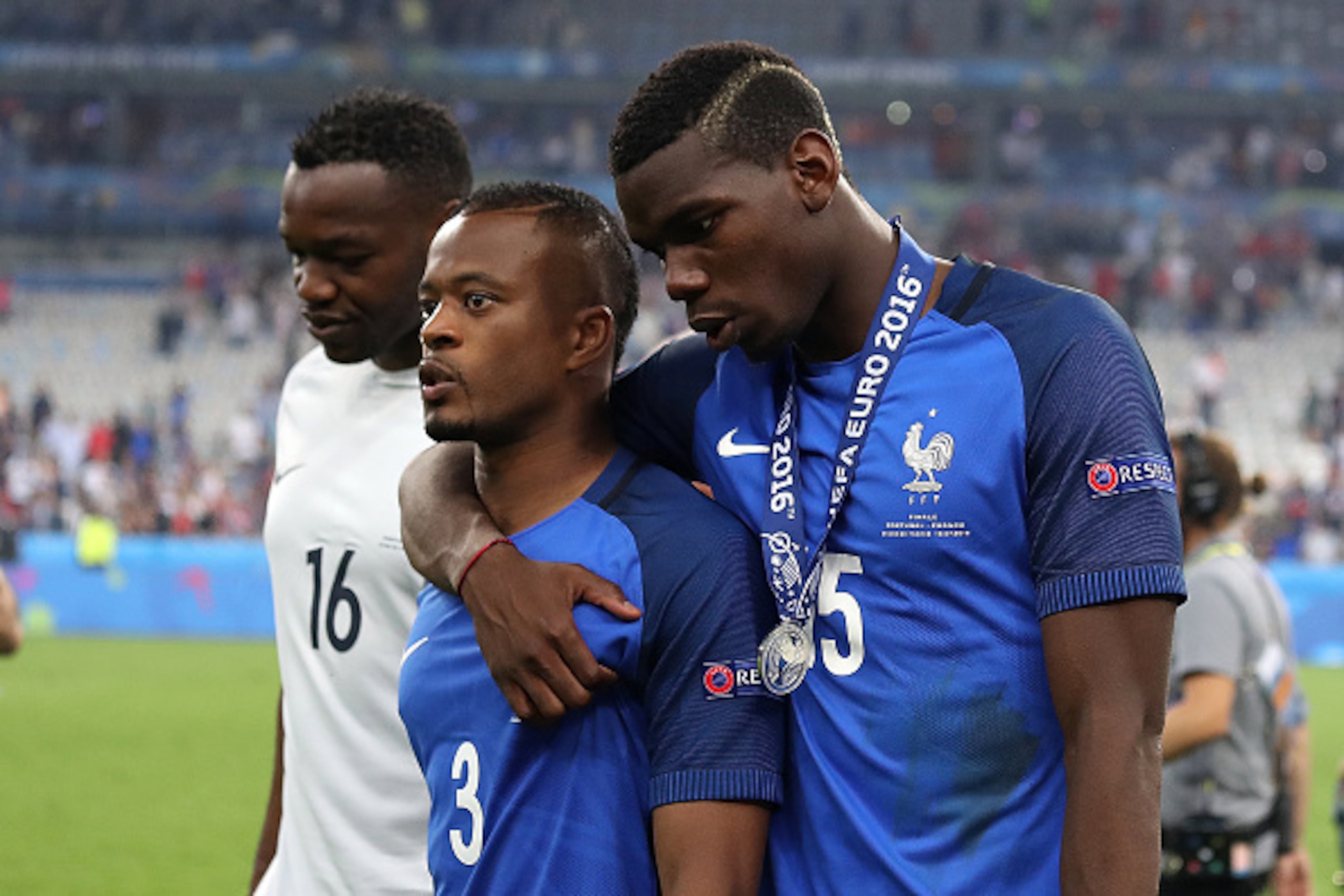 PARIS, FRANCE - JULY 10:  Patrice Evra of France is consoled by Paul Pogba at the end of the UEFA Euro 2016 Final match between Portugal and France at Stade de France on July 10, 2016 in Paris, France.  (Photo by Matthew Ashton - AMA/Getty Images)