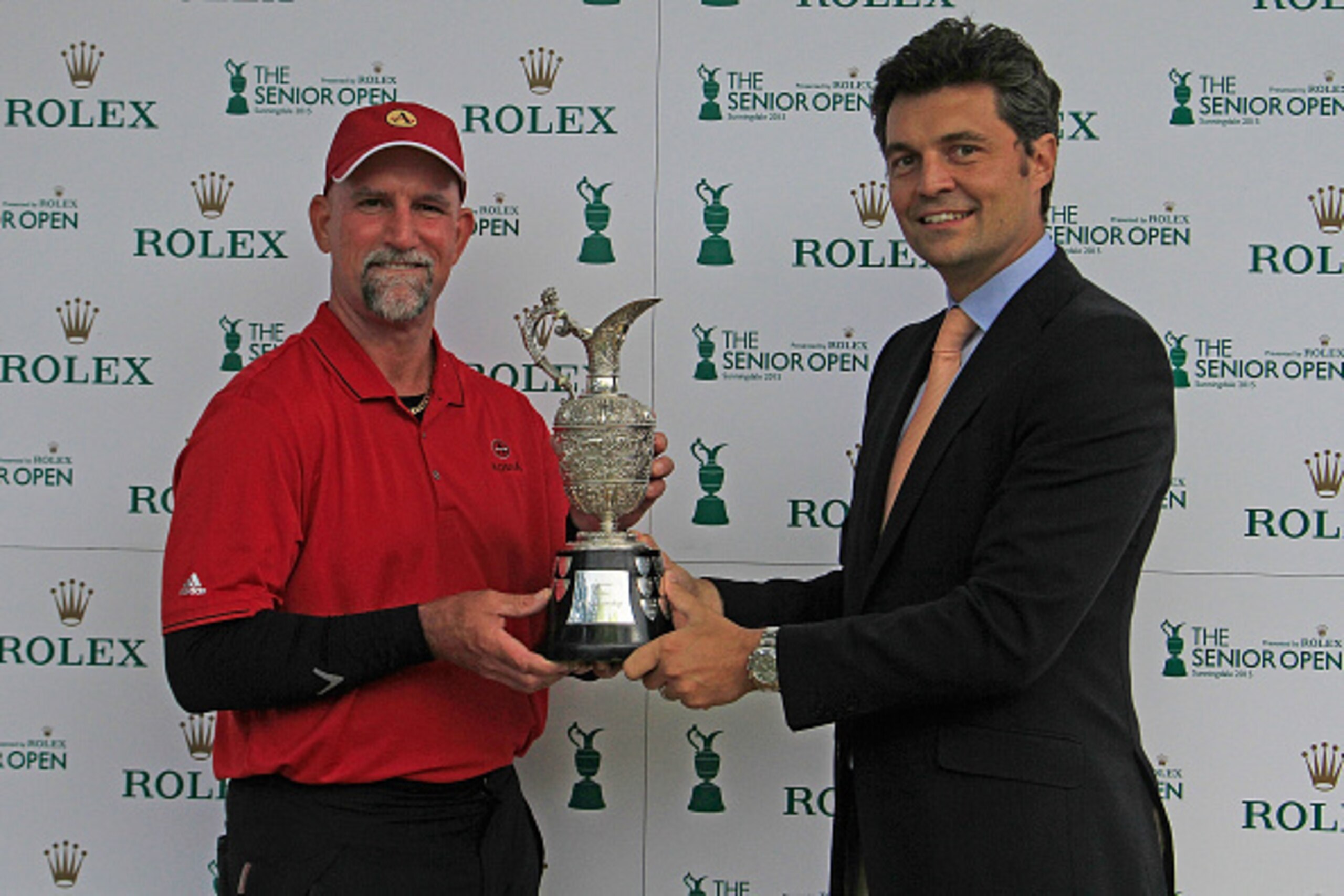 SUNNINGDALE, ENGLAND - JULY 26:  Marco Dawson of United States is presented with the trophy by Arnaud Laborde, Rolex S.A, Golf Sponsorship after the final round of The Senior Open Championship played at the Old Course, Sunningdale Golf Club on July 26, 20