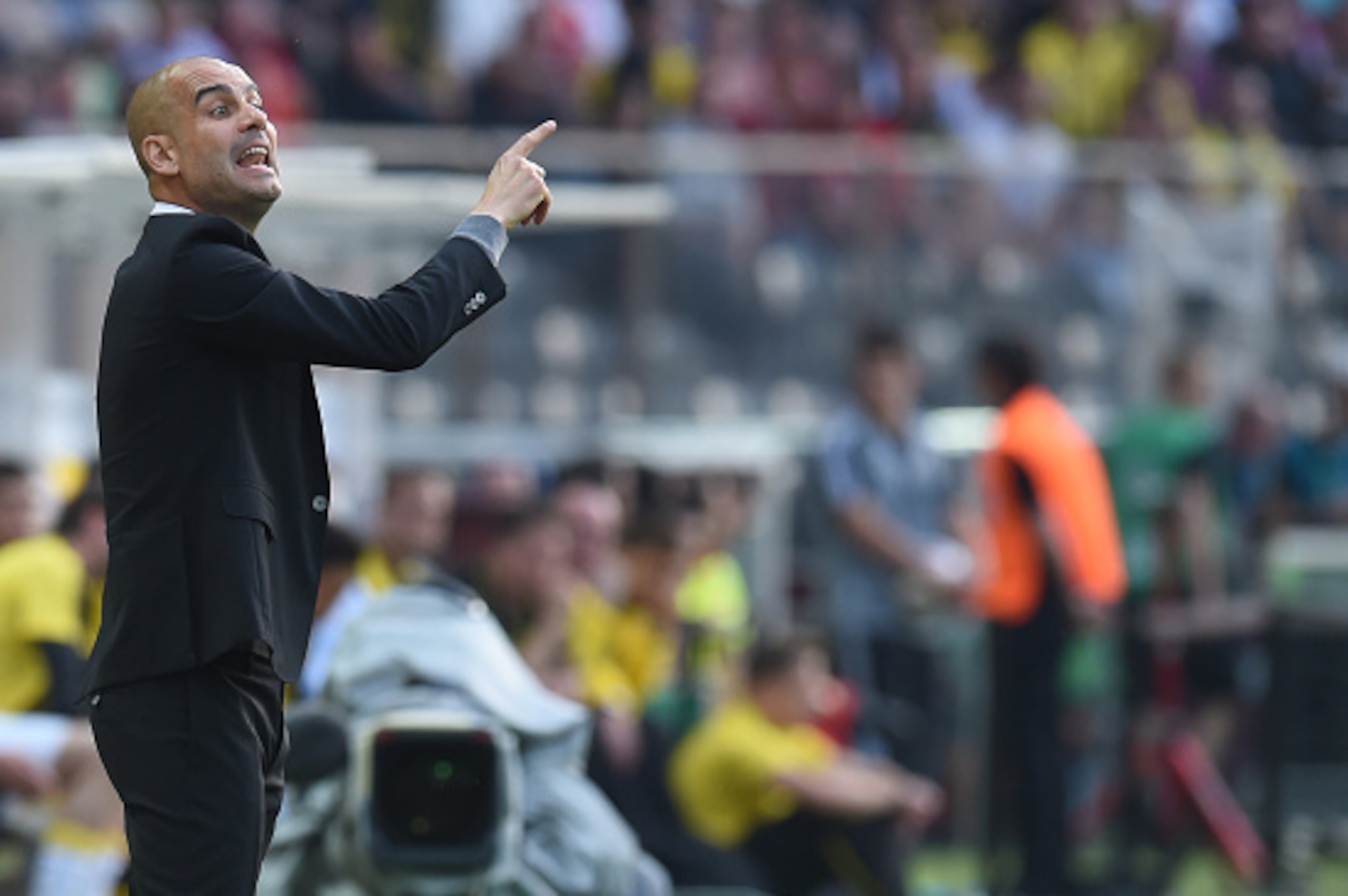 Bayern Munich's Spanish head coach Pep Guardiola gestures during the German Cup (DFB Pokal) final football match Bayern Munich vs Borussia Dortmund at the Olympic stadium in Berlin on May 21, 2016. / AFP / Christof STACHE / RESTRICTIONS: ACCORDING TO DFB 