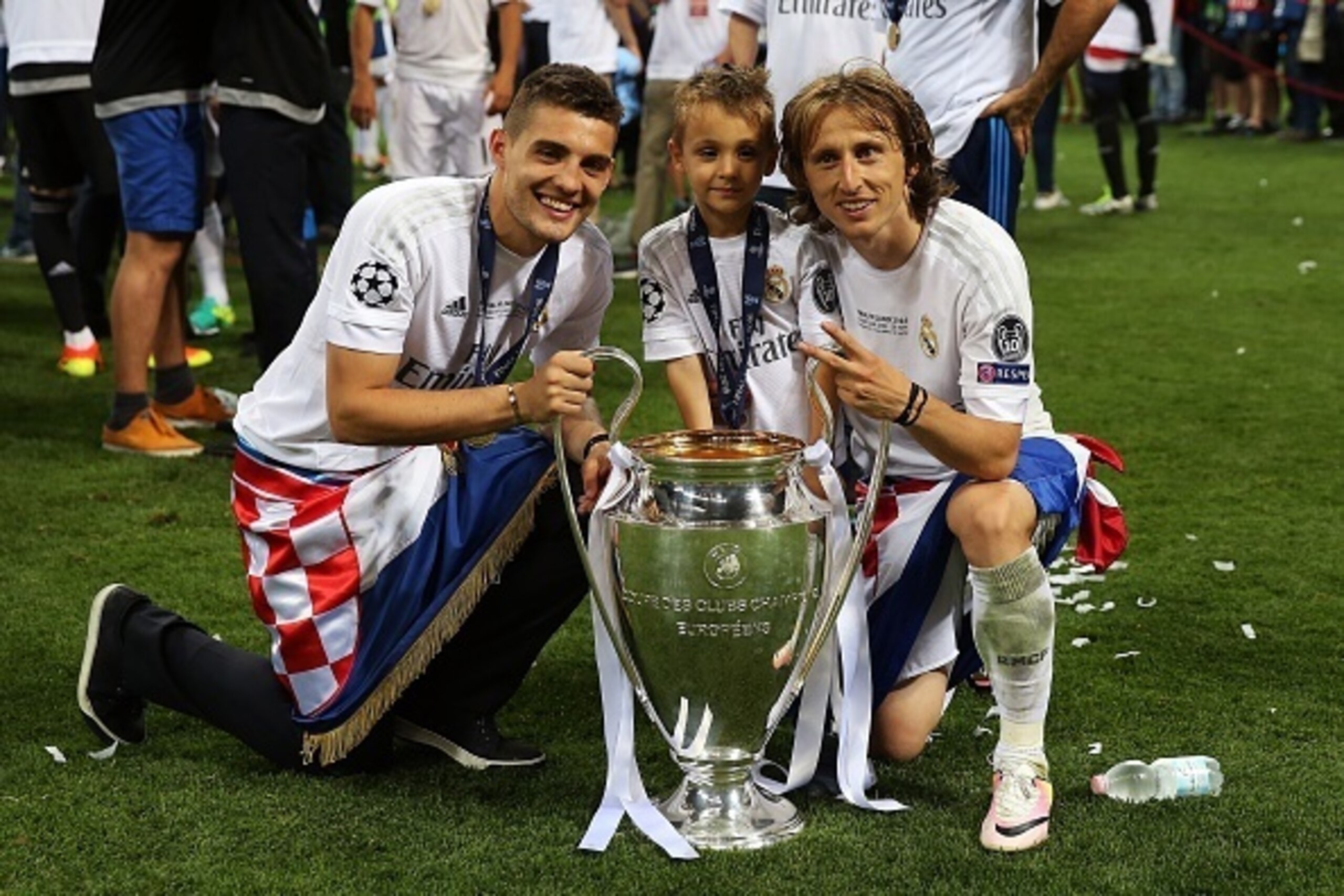 MILAN, ITALY - MAY 28: Mateo Kovacevic and Luka Modric of Real Madrid celebrate with the trophy following the UEFA Champions League Final between Real Madrid and Club Atletico de Madrid at Stadio Giuseppe Meazza on May 28, 2016 in Milan, Italy. (Photo by 