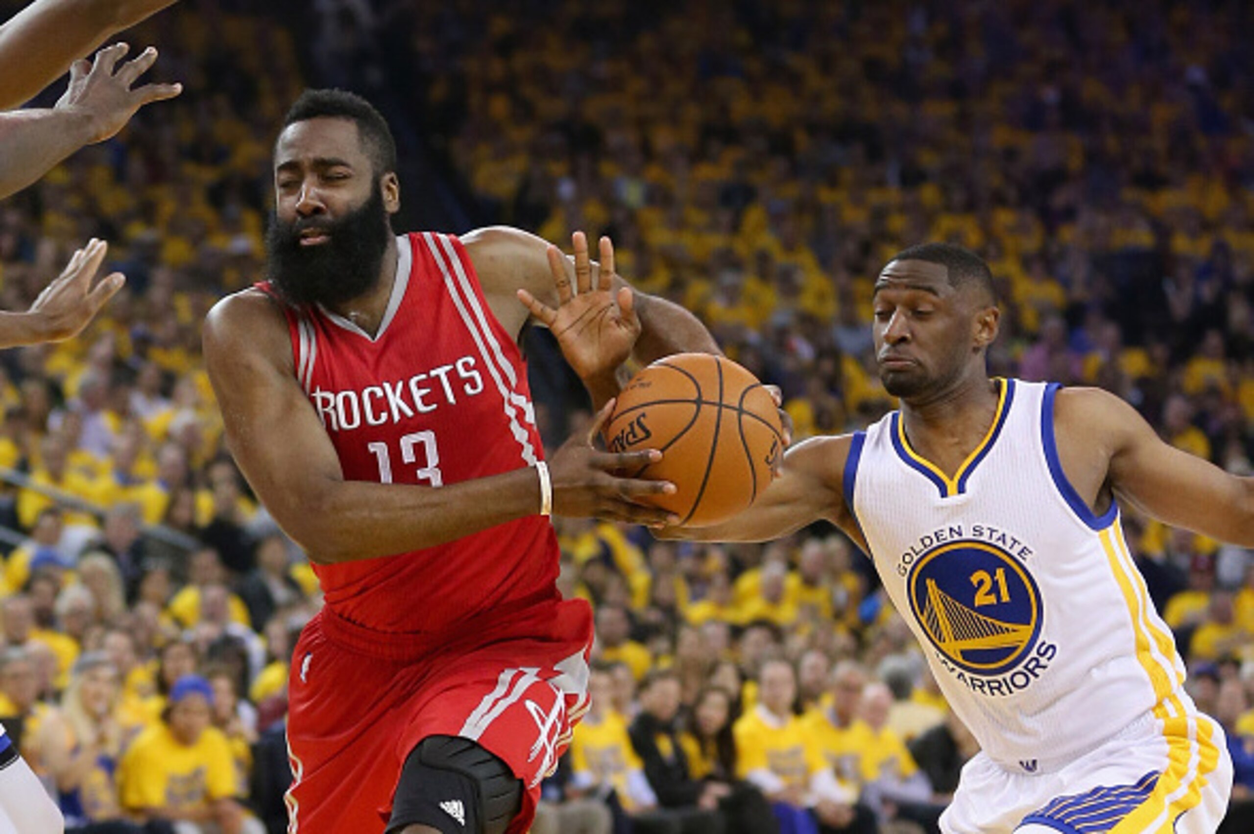 OAKLAND, CA - APRIL 27:  James Harden #13 of the Houston Rockets drives on Ian Clark #21 of the Golden State Warriors in Game Five of the Western Conference Quarterfinals during the 2016 NBA Playoffs at ORACLE Arena on April 27, 2016 in Oakland, Californi