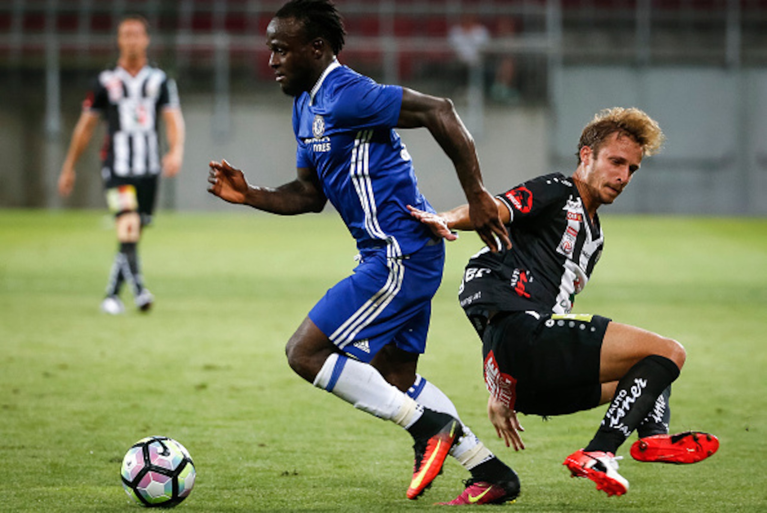 VELDEN, AUSTRIA - JULY 20: Victor Moses (L) of Chelsea in action against Michael Berger (R) of WAC RZ Pellets during the international friendly match between WAC RZ Pellets and Chelsea F.C. at Worthersee Stadion on July 20, 2016 in Velden, Austria. (Phot VELDEN, AUSTRIA - JULY 20: Victor Moses (L) of Chelsea in action against Michael Berger (R) of WAC RZ Pellets during the international friendly match between WAC RZ Pellets and Chelsea F.C. at Worthersee Stadion on July 20, 2016 in Velden, Austria. (Phot