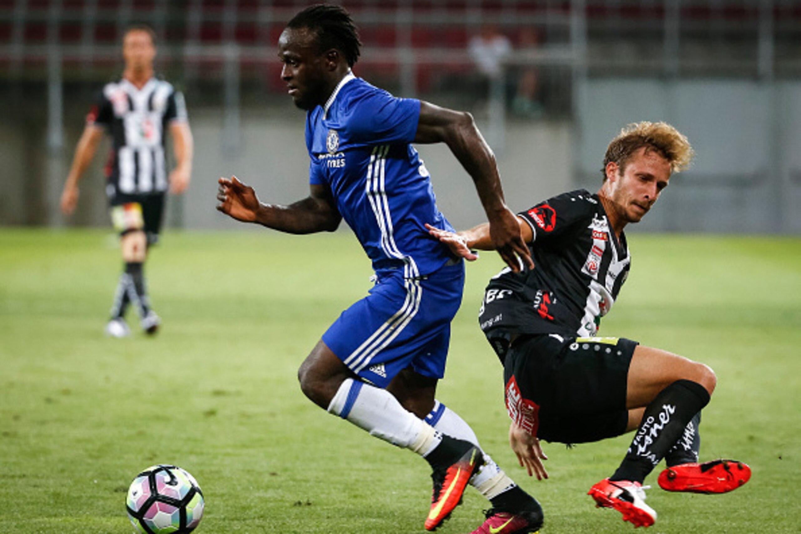 VELDEN, AUSTRIA - JULY 20:  Victor Moses (L) of Chelsea in action against Michael Berger (R) of WAC RZ Pellets during the international friendly match between WAC RZ Pellets and Chelsea F.C. at Worthersee Stadion on July 20, 2016 in Velden, Austria. (Phot