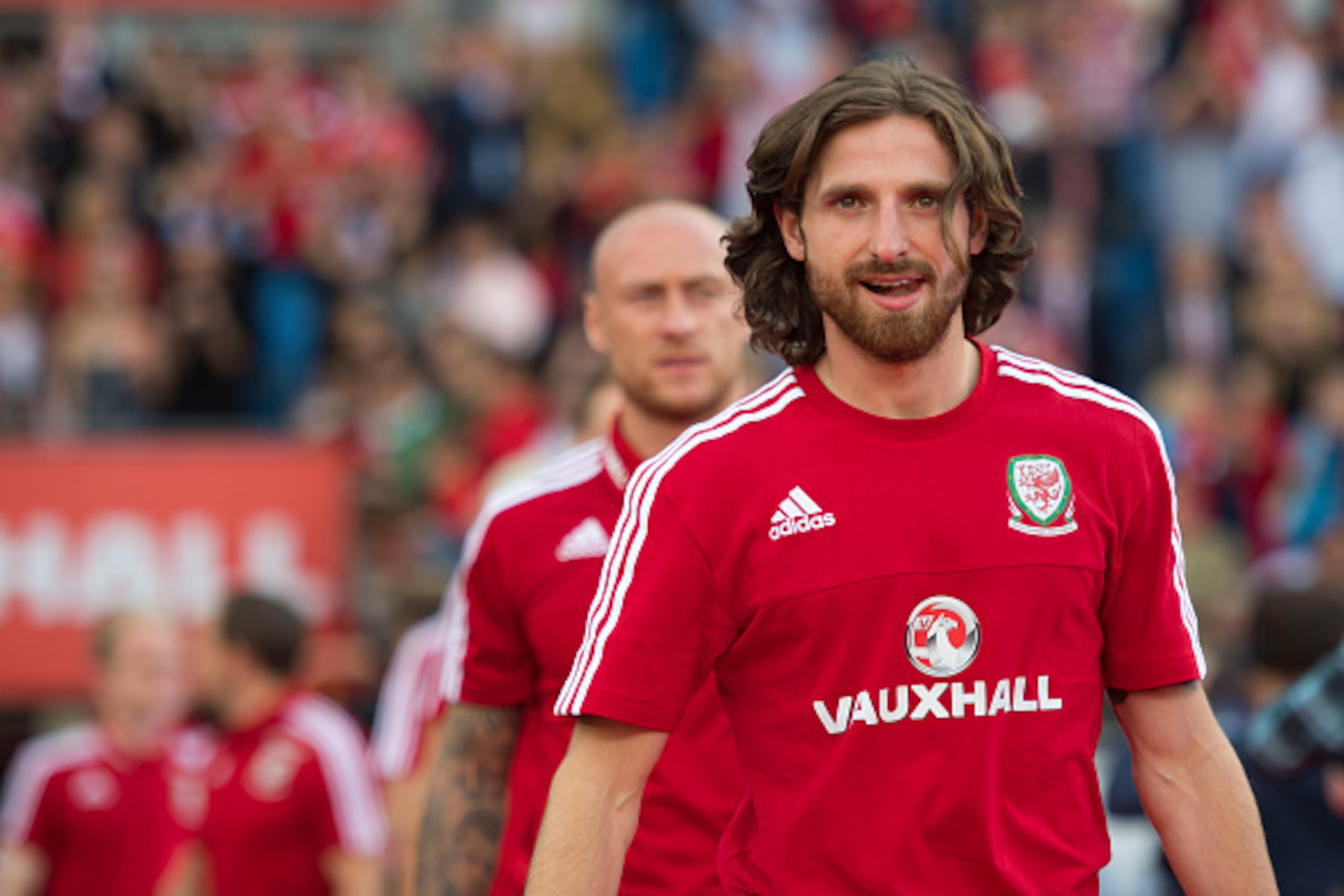 CARDIFF, WALES - JULY 08: Wales' Joe Allen walks onto the pitch during a ceremony at the Cardiff City Stadium on July 8, 2016 in Cardiff, Wales. The players toured the streets of Cardiff in an open top bus before arriving at the Cardiff City Stadium for a