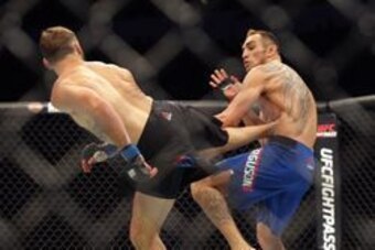 Jul 13, 2016; Sioux Falls, SD, USA; Tony Ferguson (red gloves) fights against Lando Vannata (blue gloves) during UFC Fight Night at Denny Sanford Premier Center. Mandatory Credit: Brad Rempel-USA TODAY Sports